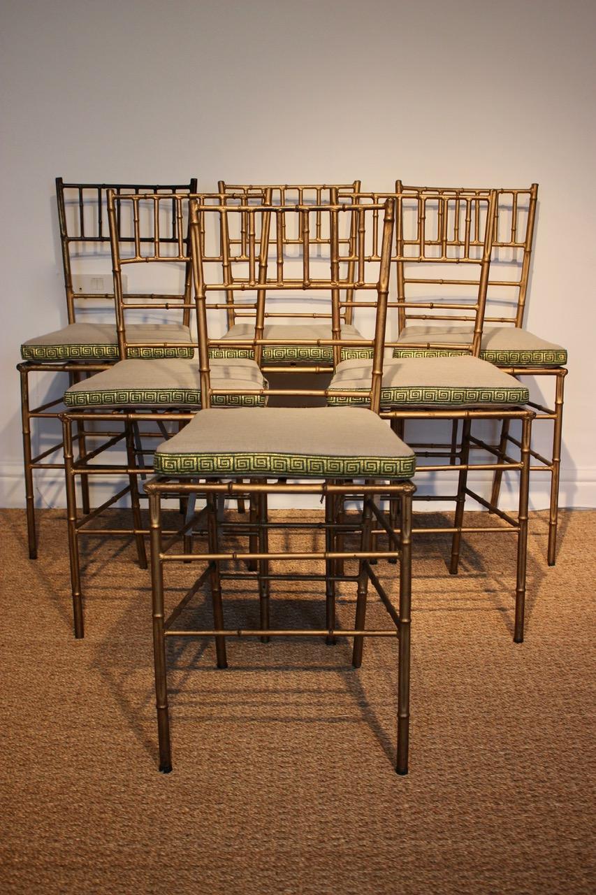 A very stylish set of six, circa 1940s, faux bamboo gilded metal Spanish dining chairs / occasional chairs with newly upholstered seat cushions in plain linen with Greek key borders, that will work very well in many interiors. 

Spain circa 1940s
