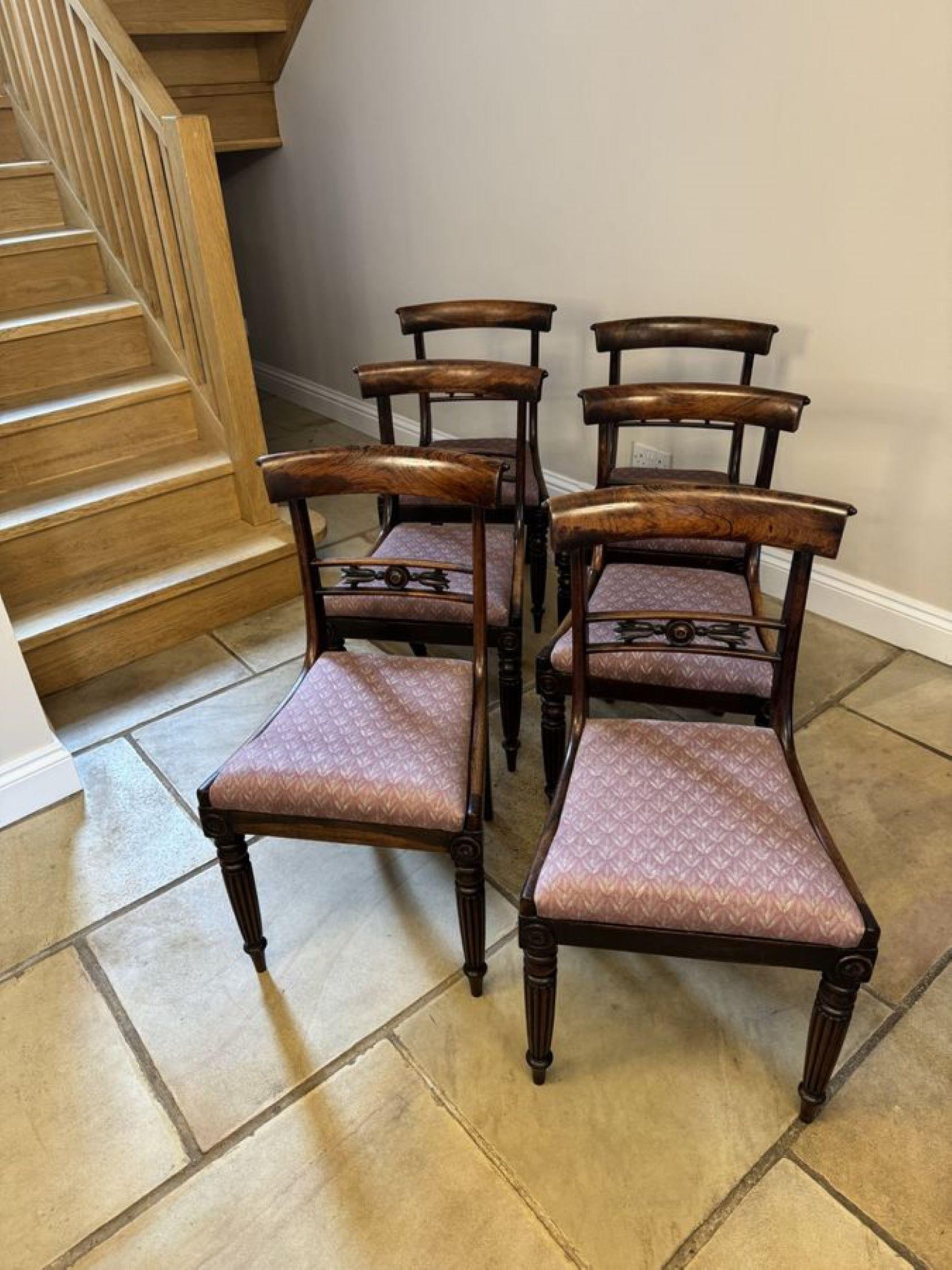 Wonderful set of six antique regency quality rosewood dining chairs, having a quality rosewood top carved centre splat, drop in seats, standing on elegant reeded tapering legs to the front and out swept legs to the back.

D. 1825