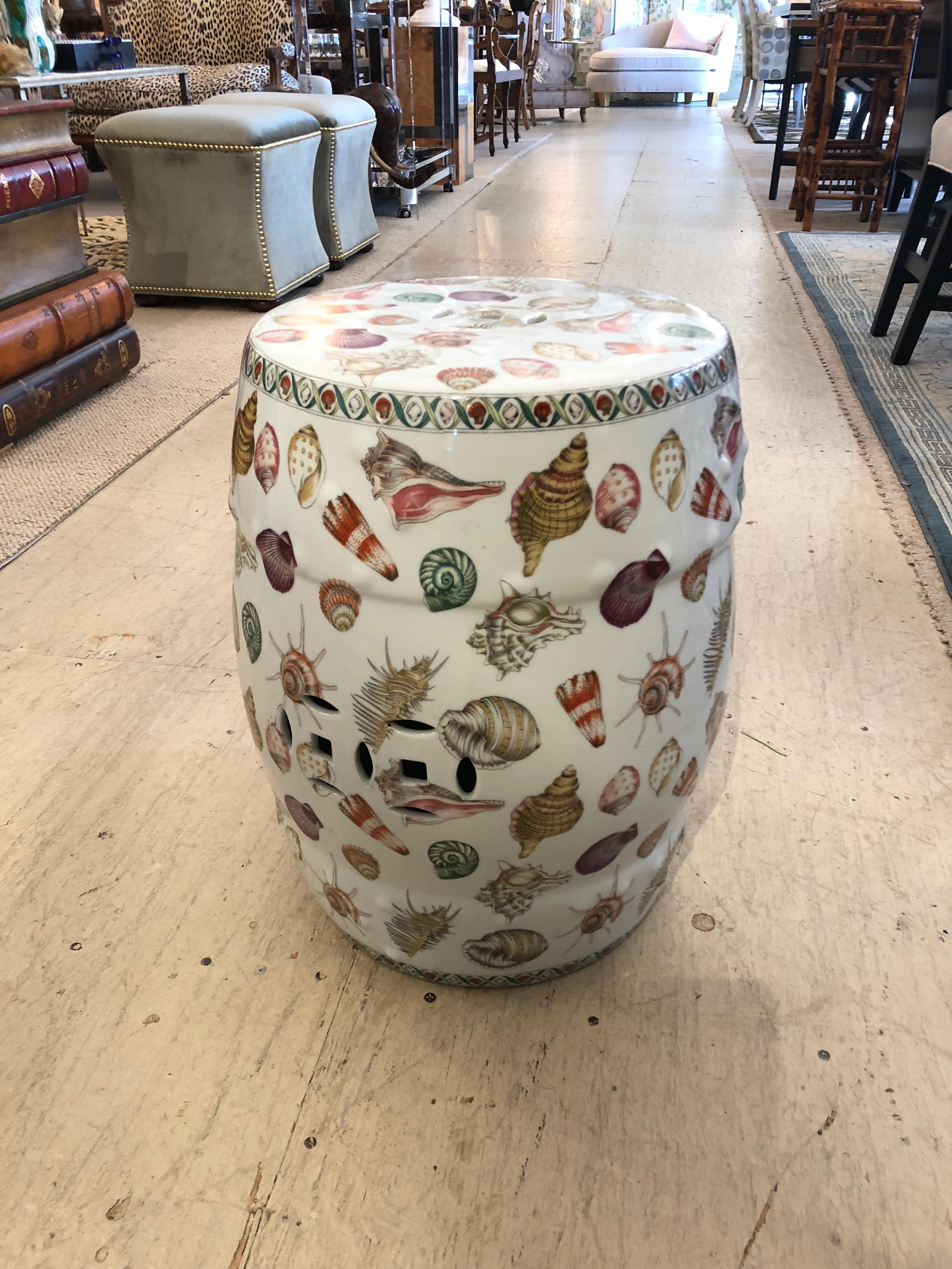 Delightfully decorated white porcelain garden seat end table adorned with renderings of seashells.