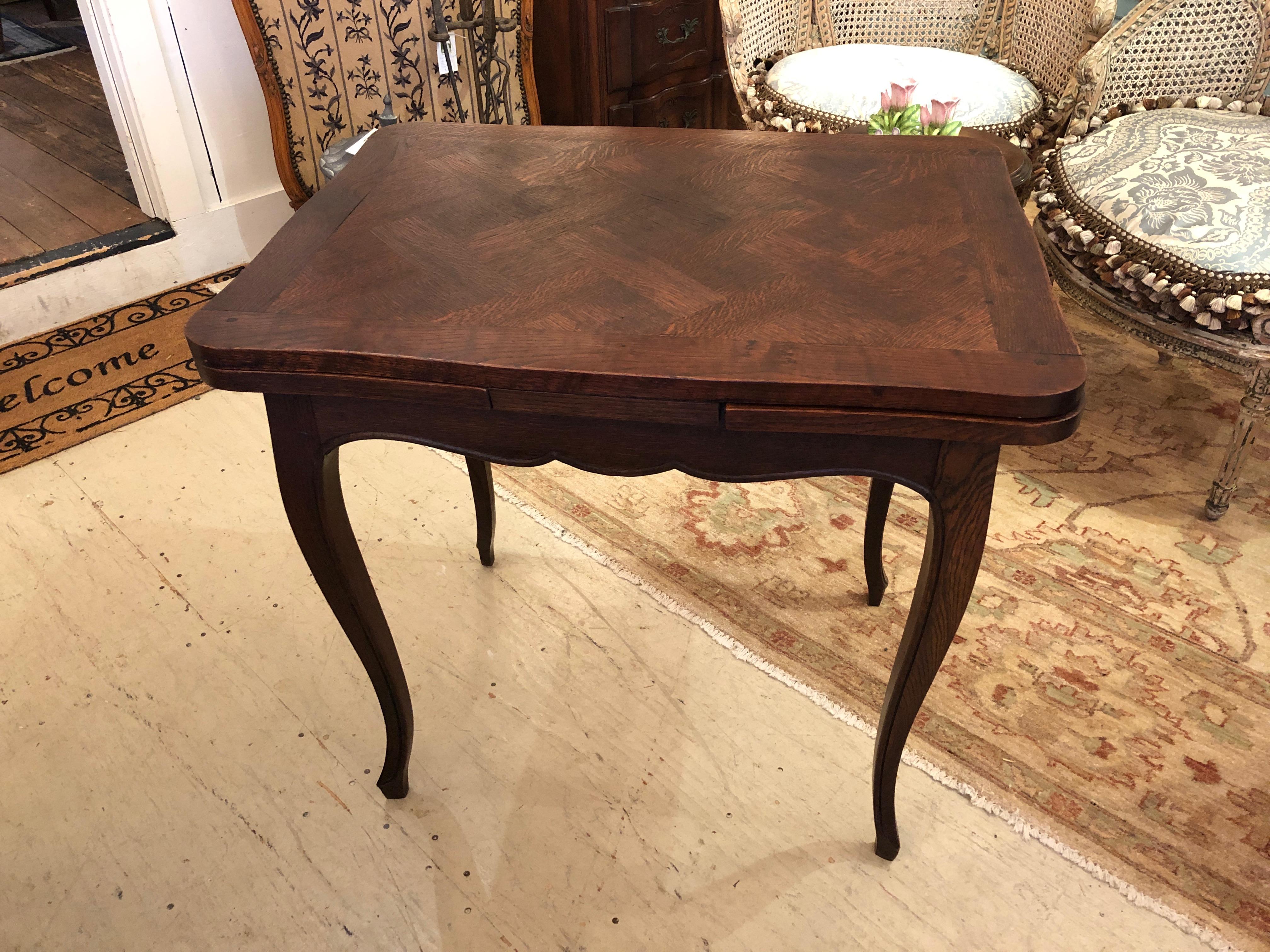 A remarkably versatile side table having beautiful walnut marquetry top and cabriole legs, that expands with two leaves at each end to become a functional dining table for a small space.
Closed measures: 31.25” W x 29” H x 23.5” D.