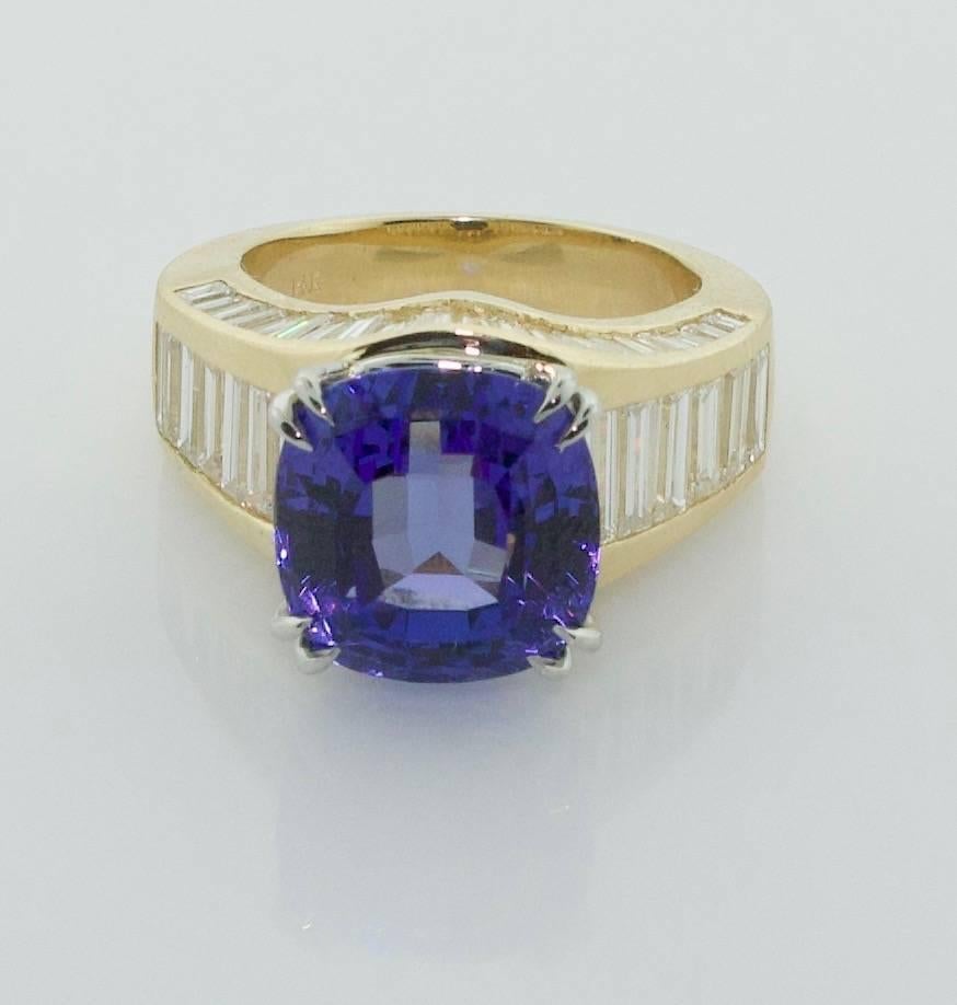 Wonderful Tanzanite and Diamond Ring in 18k Yellow Gold
A Extremely Vibrant Cushion Cut Tanzanite weighing 8.64 Perfect Color and Clarity
A Custom Handmade Ring Forty Tapered Baguette Diamonds weighing 1.80 carats (approximately) 
The Jewelry Work