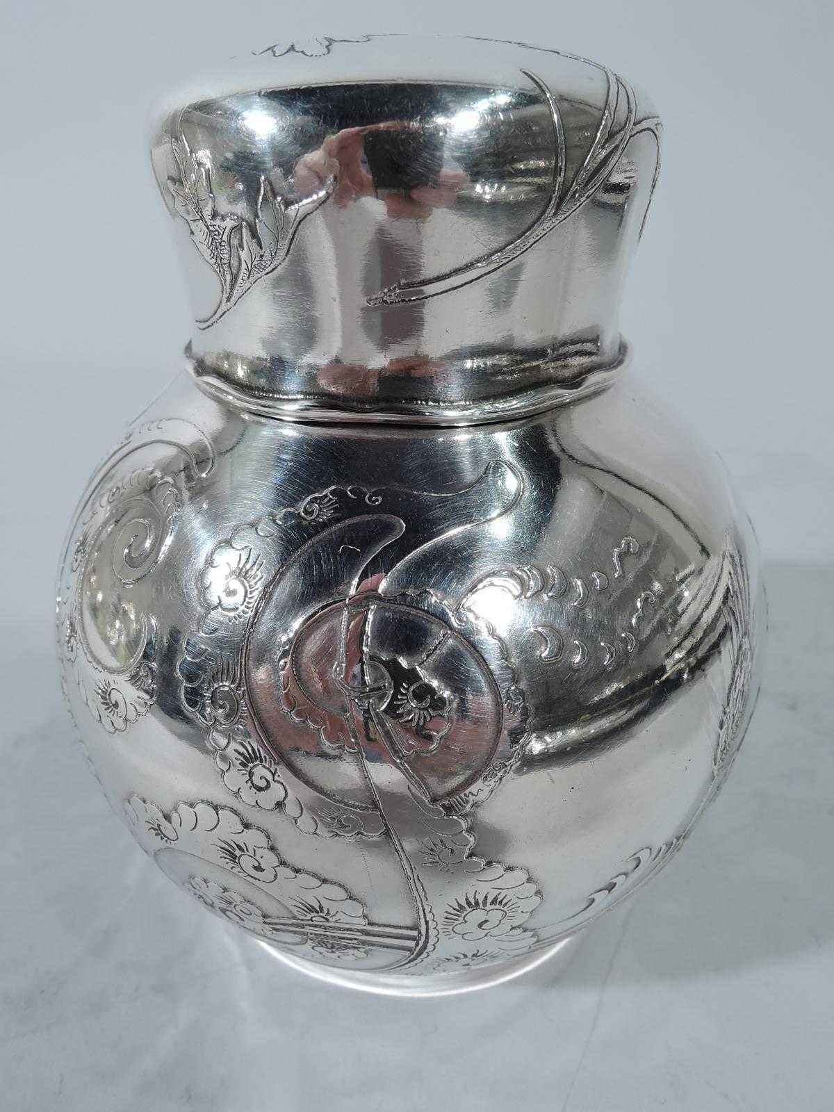 Aesthetic sterling silver tea caddy. Made by Tiffany & Co. in New York, circa 1877. Globular with short neck, interior cap, and snug-fitting cover. Acid-etched ornament heightened with engraving. Naturalistic plants (including thistles, daisies, and