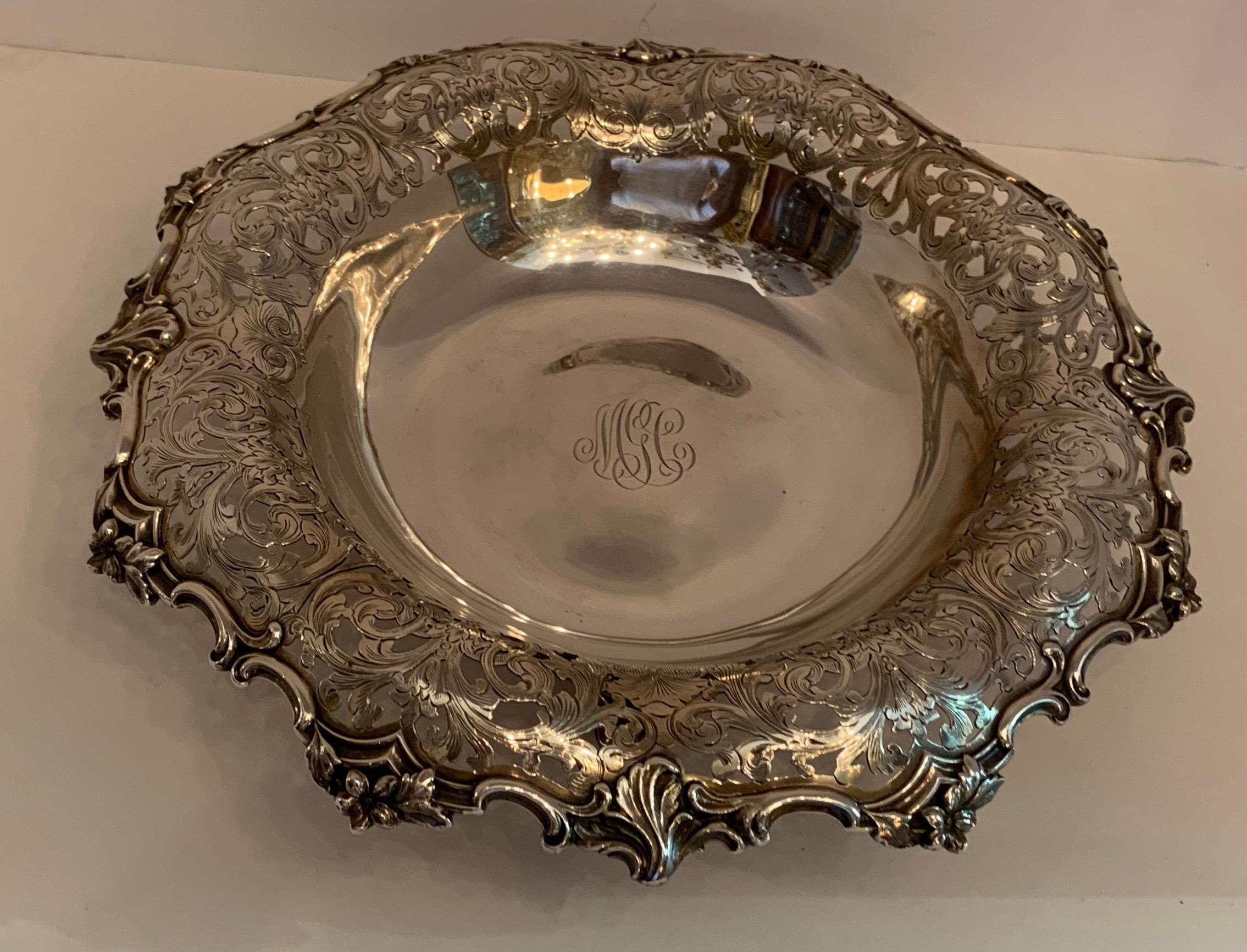 Tiffany & Co. sterling silver centerpiece footed pierced bowl, with slightly turned over scrolling foliage and floral rim and four scrolled feet, circa 1901.
Measures: Approx. 3