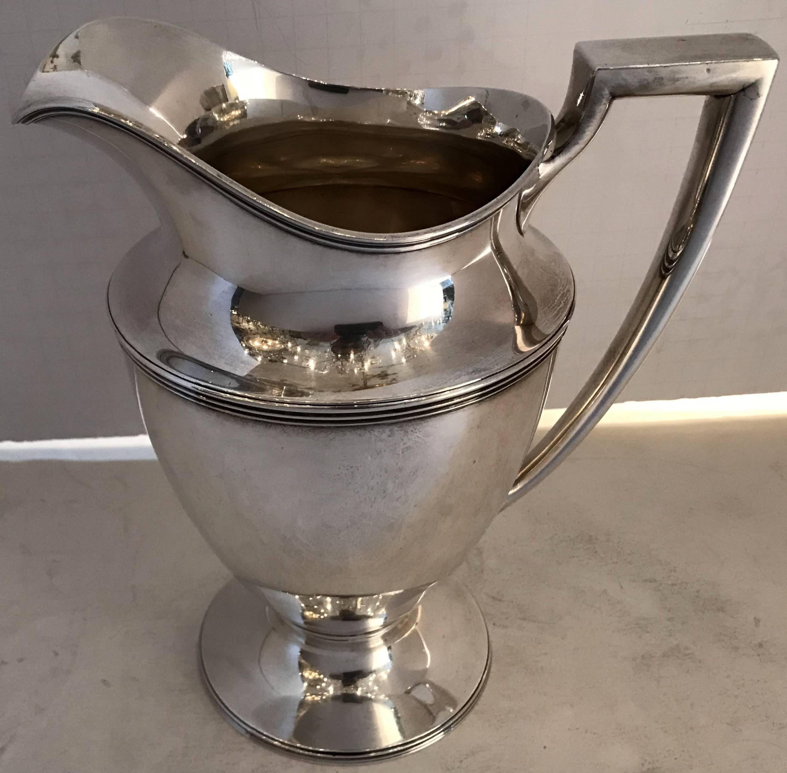 A wonderful Tiffany & Co. Mid-Century Modern sterling silver ribbed and handle water pitcher.