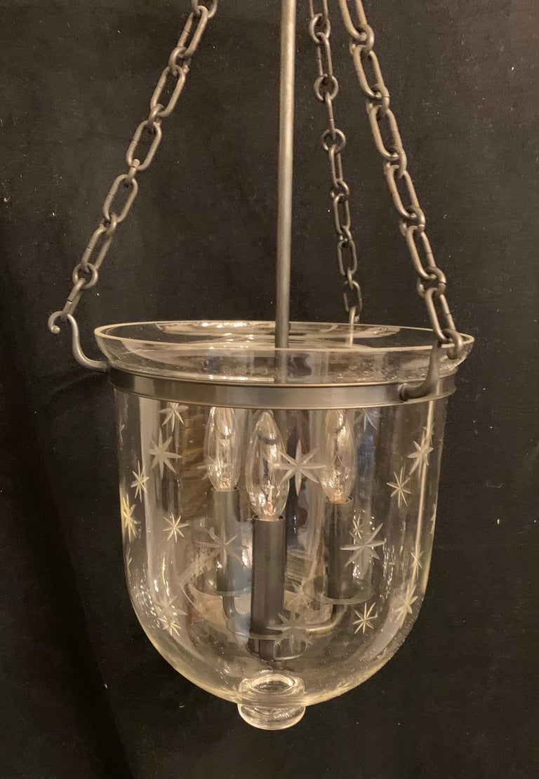 A wonderful Vaughan designs patinated bronze & glass star pattern bell jar 3-light lantern fixture.