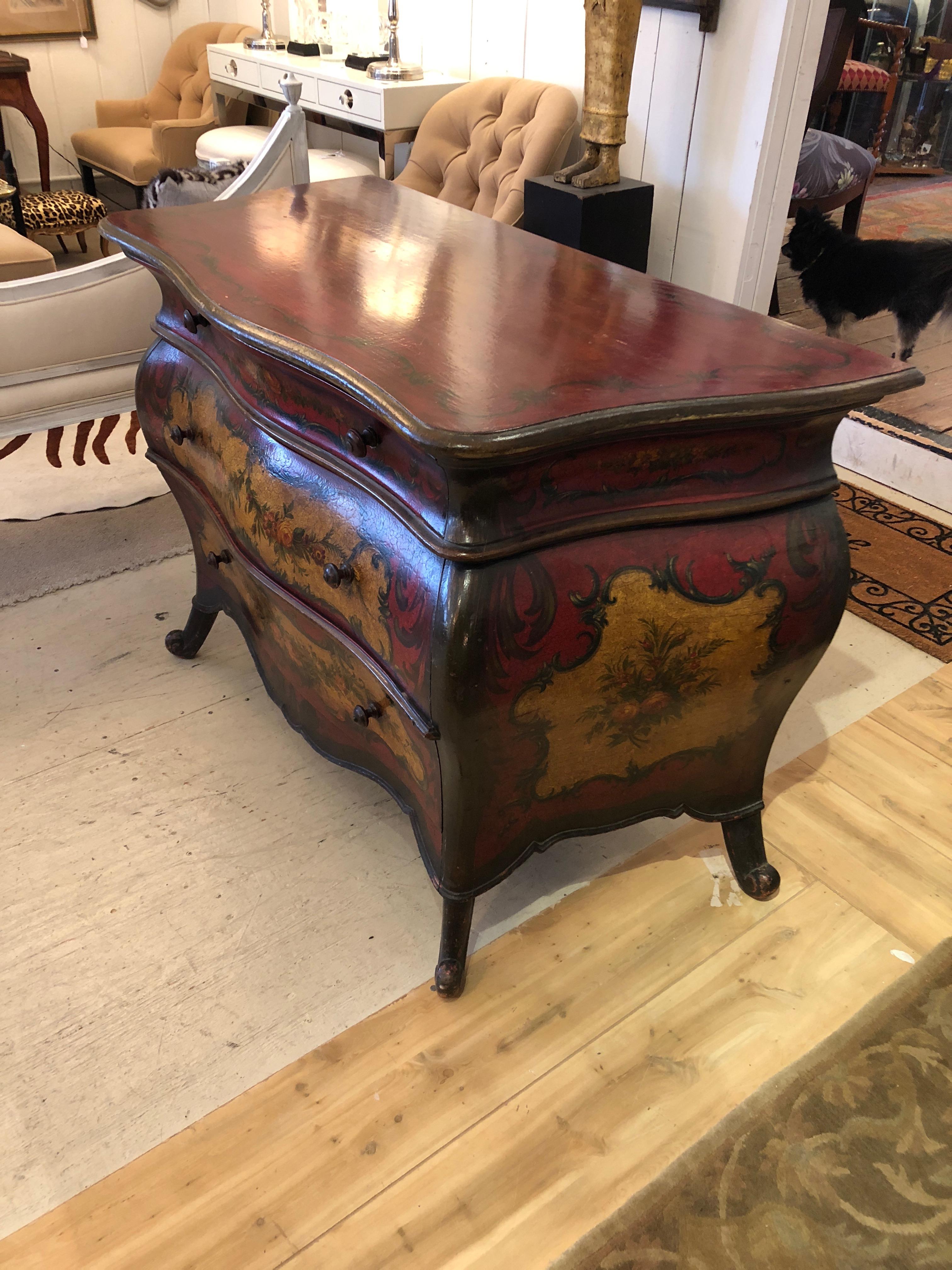 A richly painted barn red antique bombay commode having wonderful foliage decoration, cream background on the three drawers, original turned wood knobs and sassy splayed feet.
Drawers work smoothly.