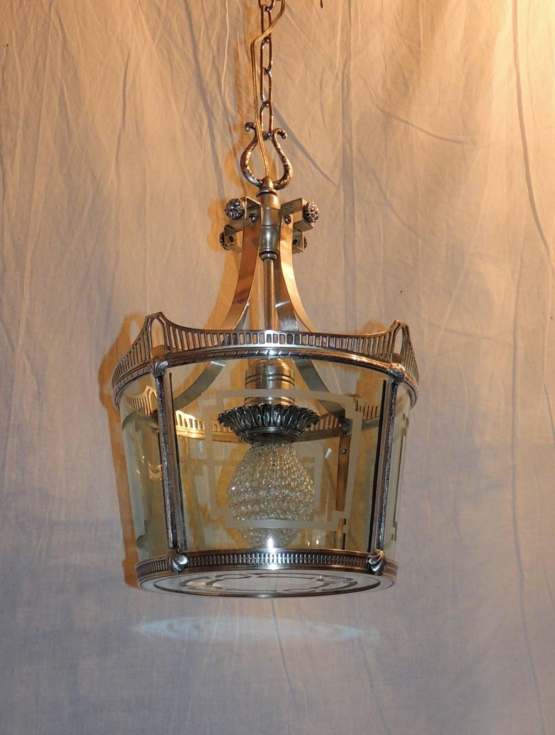 Wonderful pierced rims surround the beautiful etched glass of this charming silver lantern, with filigree detail on top and canopy.

Measures: 19