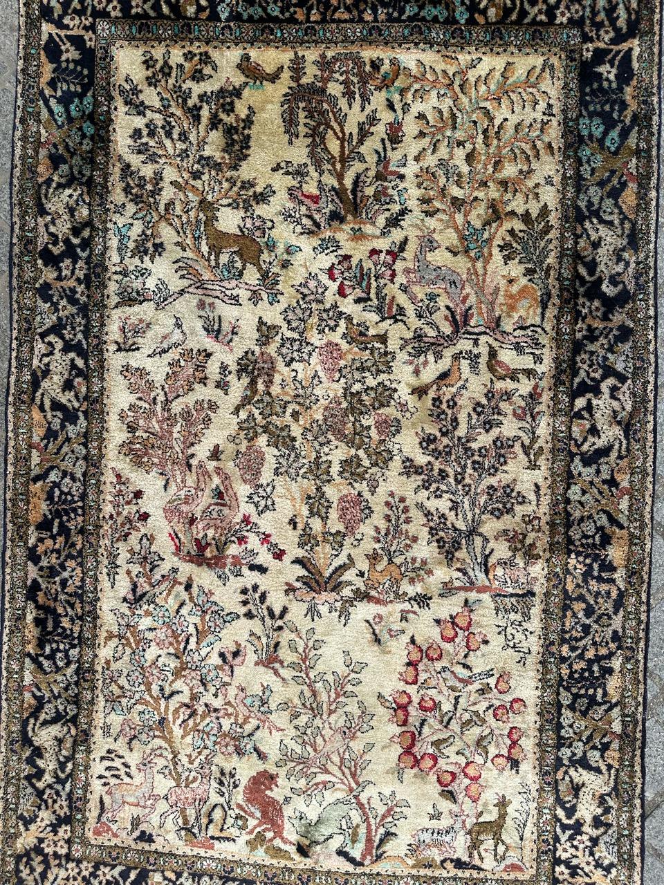 Very beautiful midcentury silk Qom rug with a garden design with birds and animals, and nice colours with a nice beige field, pink, red, green, blue and navy blue, very decorative, entirely and finely hand knotted with silk velvet on silk foundation.