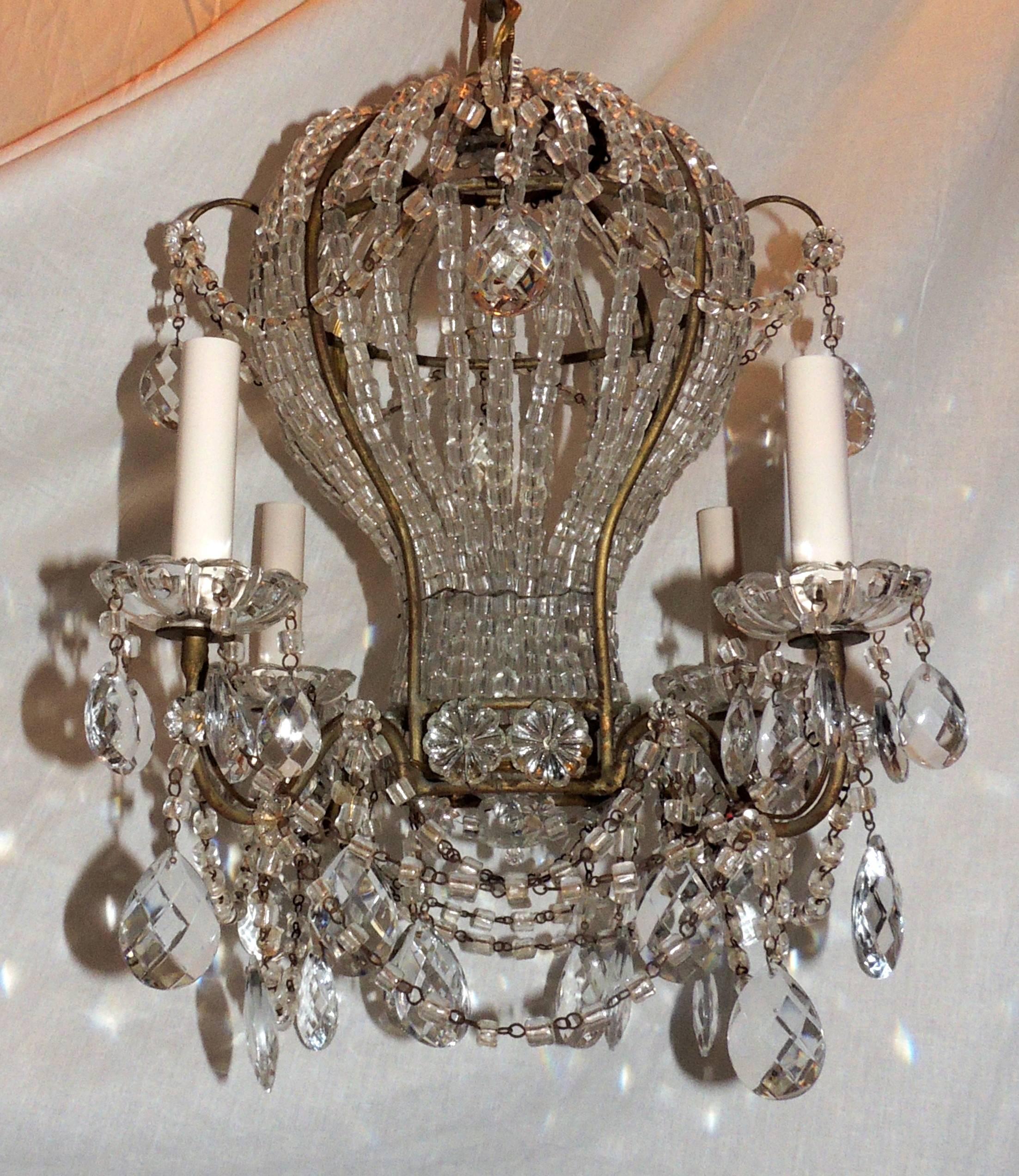 A wonderful vintage Italian gilt and macaroni beaded crystal hot air balloon chandelier, light fixture with beaded crystal swags and adorned with cut crystal drops throughout. Completely redone and comes ready to install.

Actual fixture