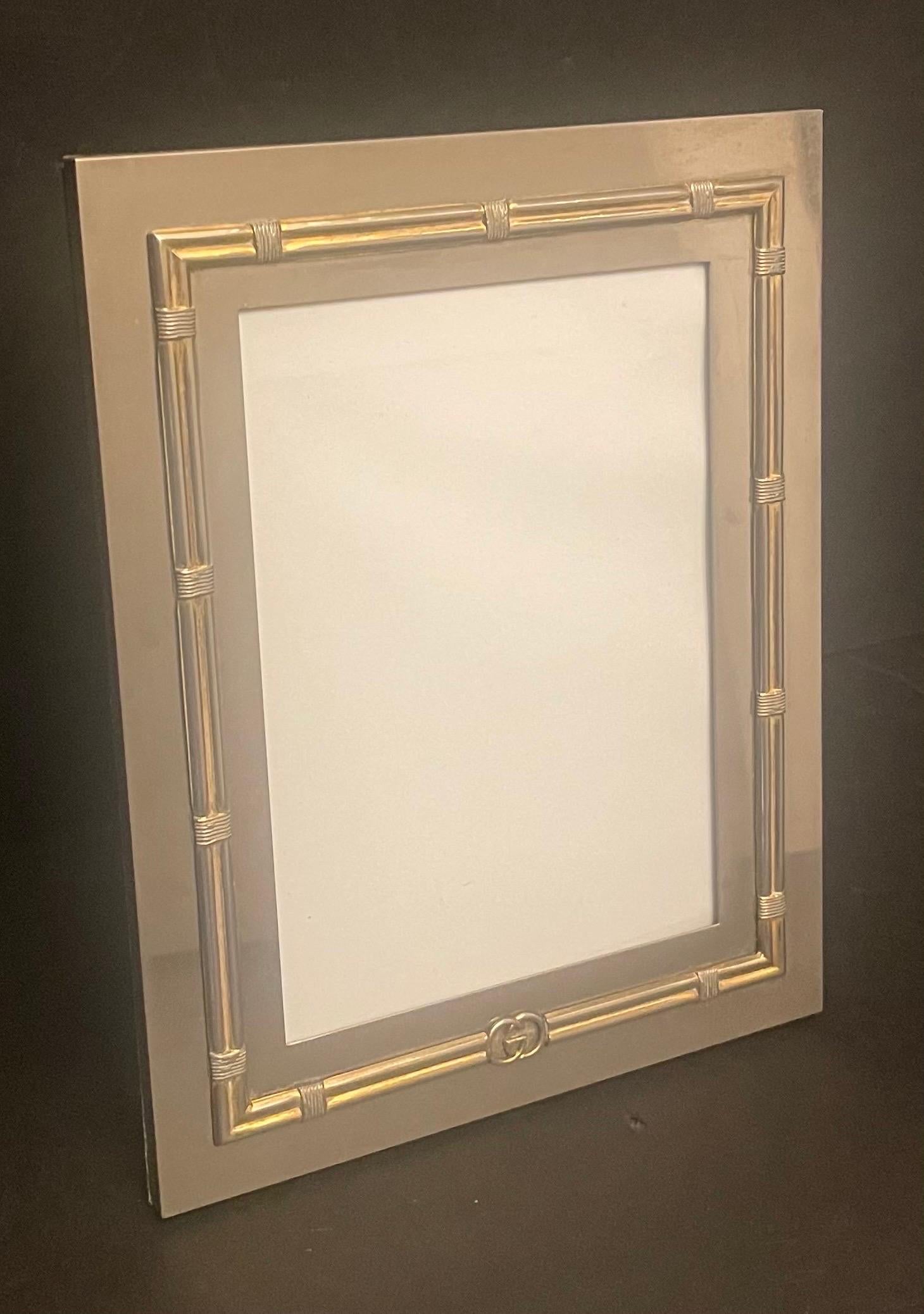 Wonderful vintage Gucci silver-plate picture frame embellished with a gilt brass border and the GUCCI emblem on the center bottom, the back of exotic wood veneer.
Measurements:
10