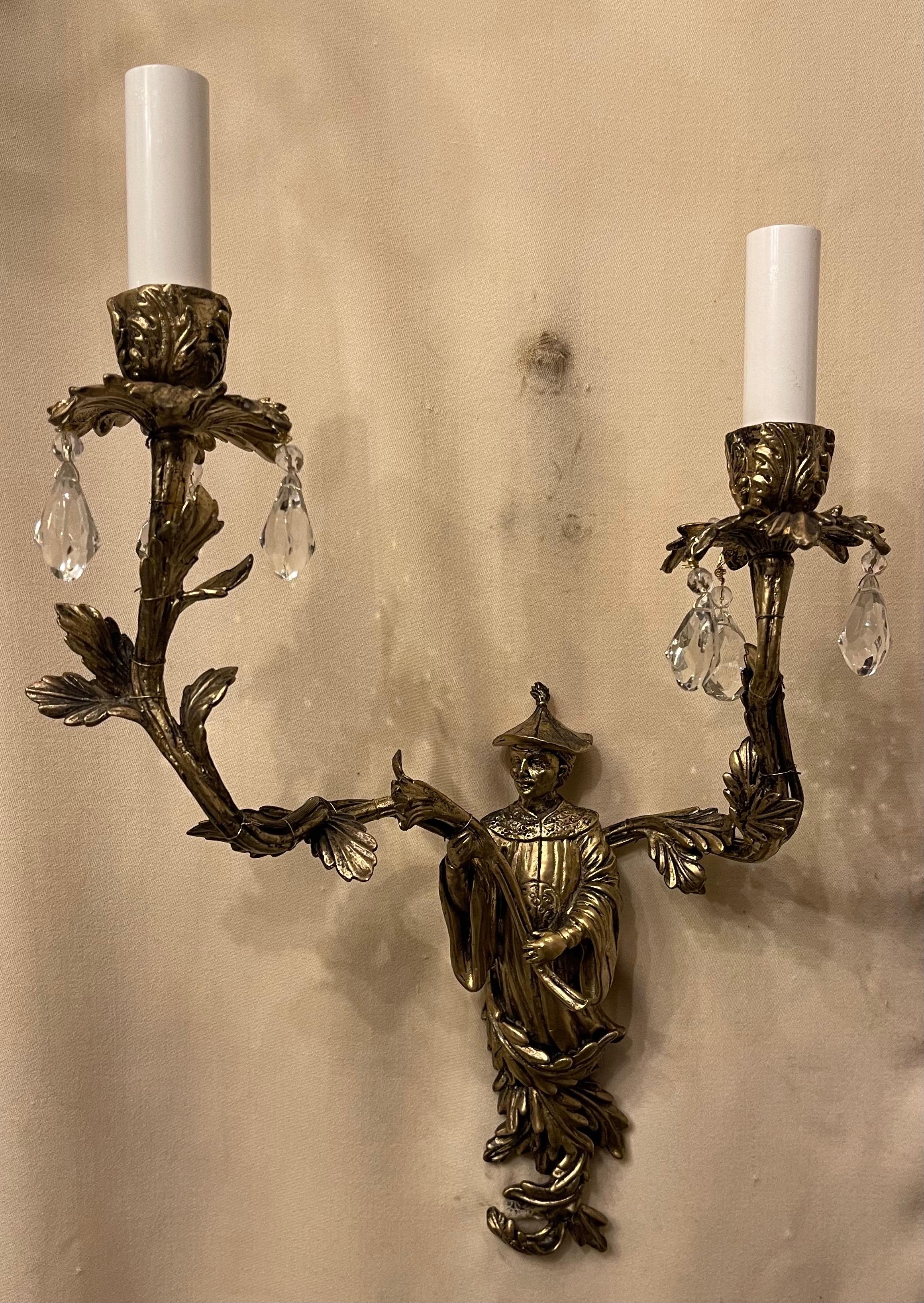 A wonderful vintage pair of bronze chinoiserie figure and crystal drop two candelabra light sconces, rewired with new sockets and ready to install.