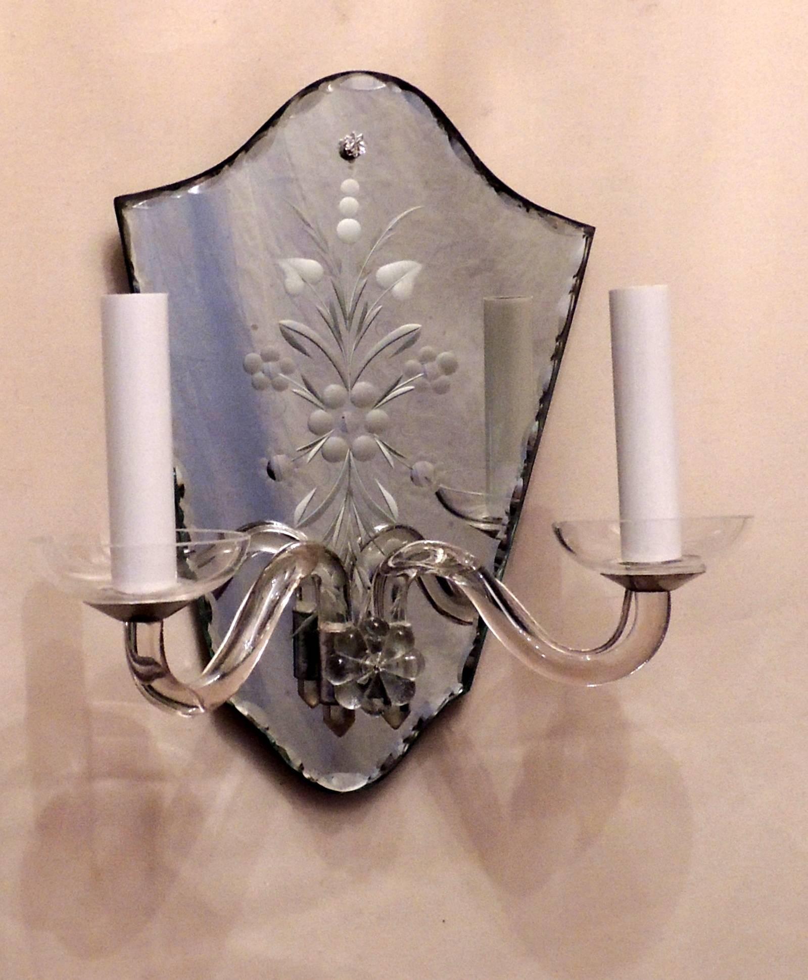 A wonderful vintage pair of etched mirror back and crystal / glass arm and flower, shield back form two-light sconces completely redone from wiring to sockets and are ready to enjoy.
