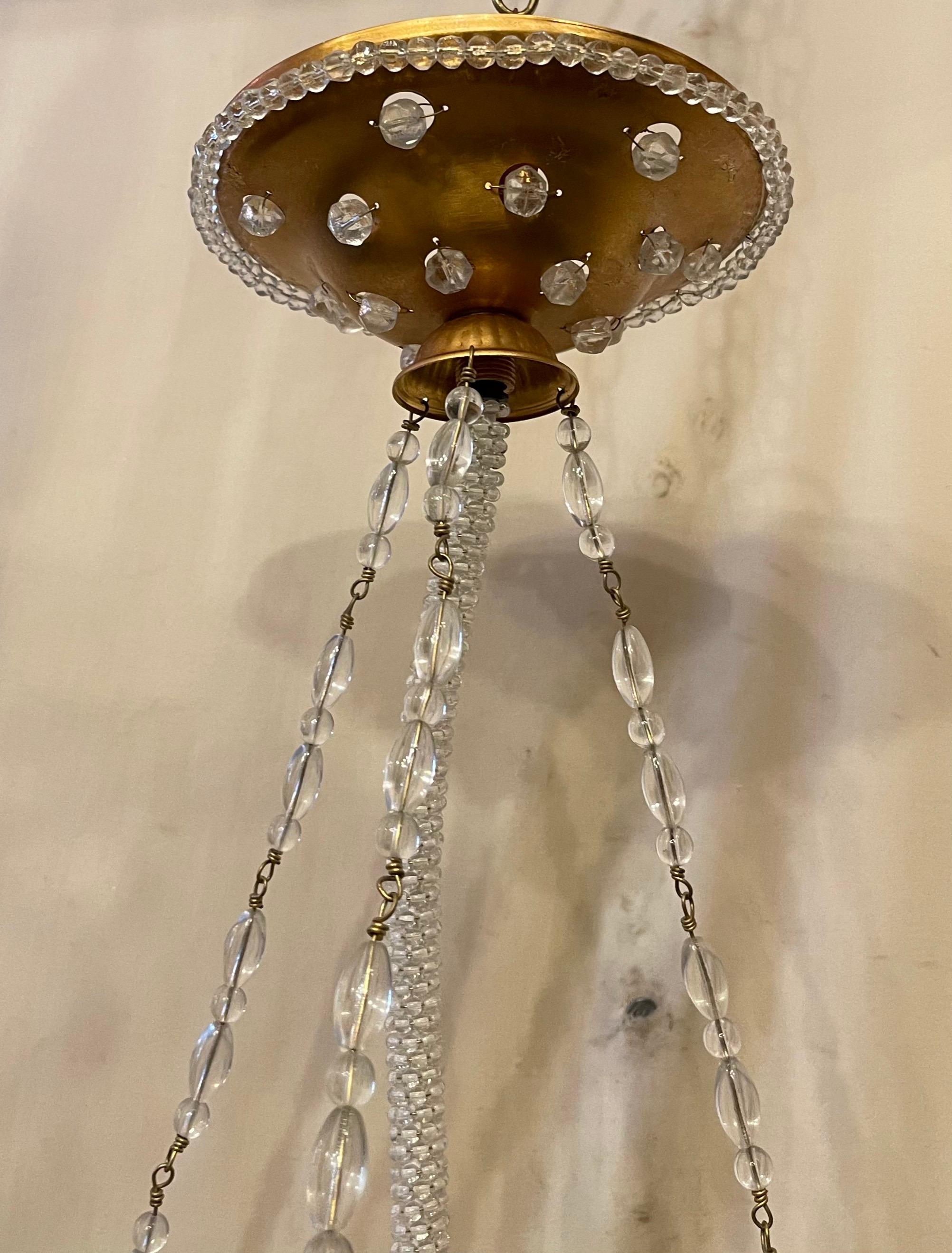 A wonderful vintage Sherle Wagner beaded hanging crystal basket gold light fixture with single edison socket.