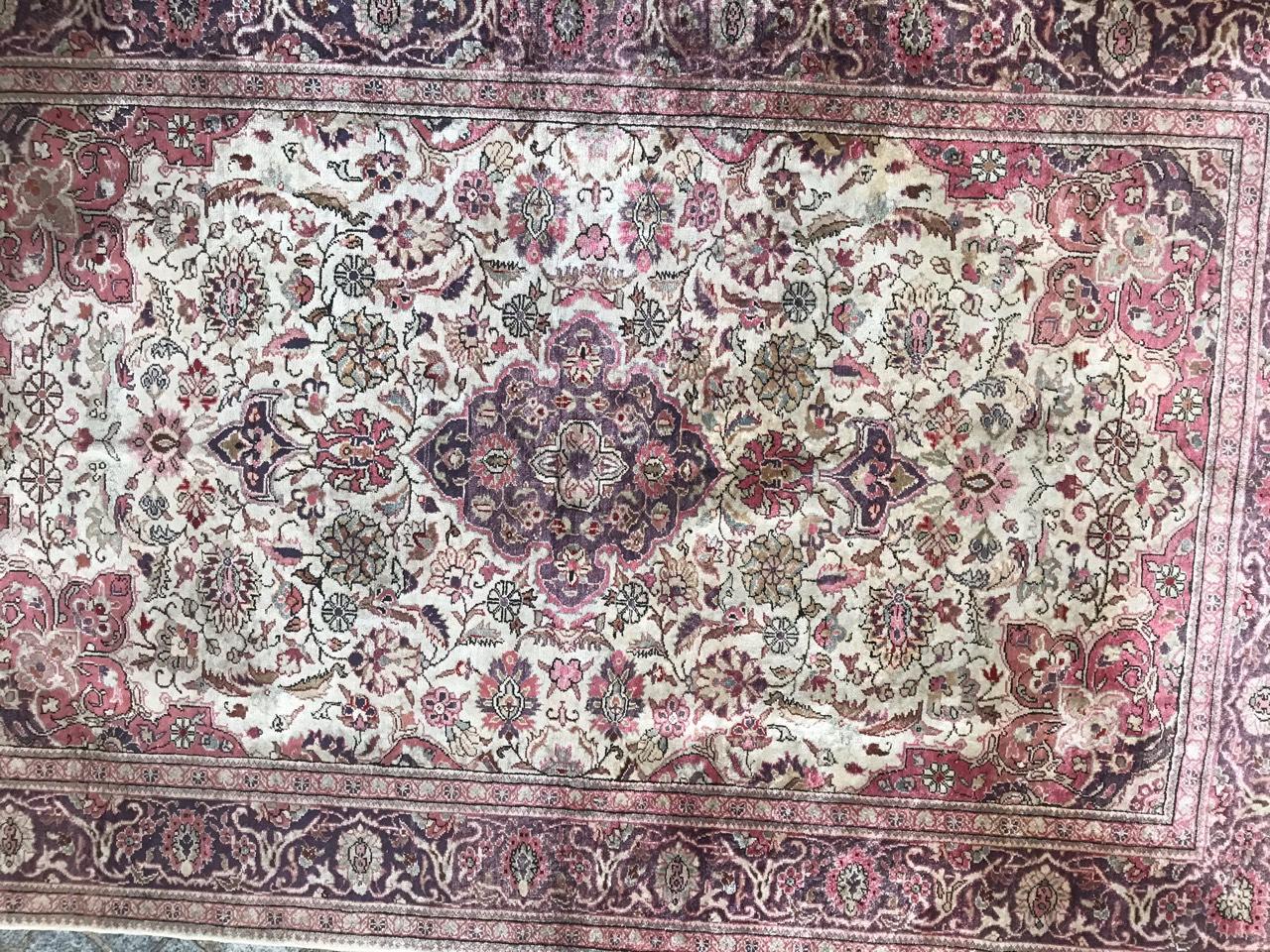 Beautiful late 20th century silk Turkish rug with beautiful floral central medallion design and light colors with purple, pink and grey on white field, entirely hand knotted with silk velvet on cotton foundation.