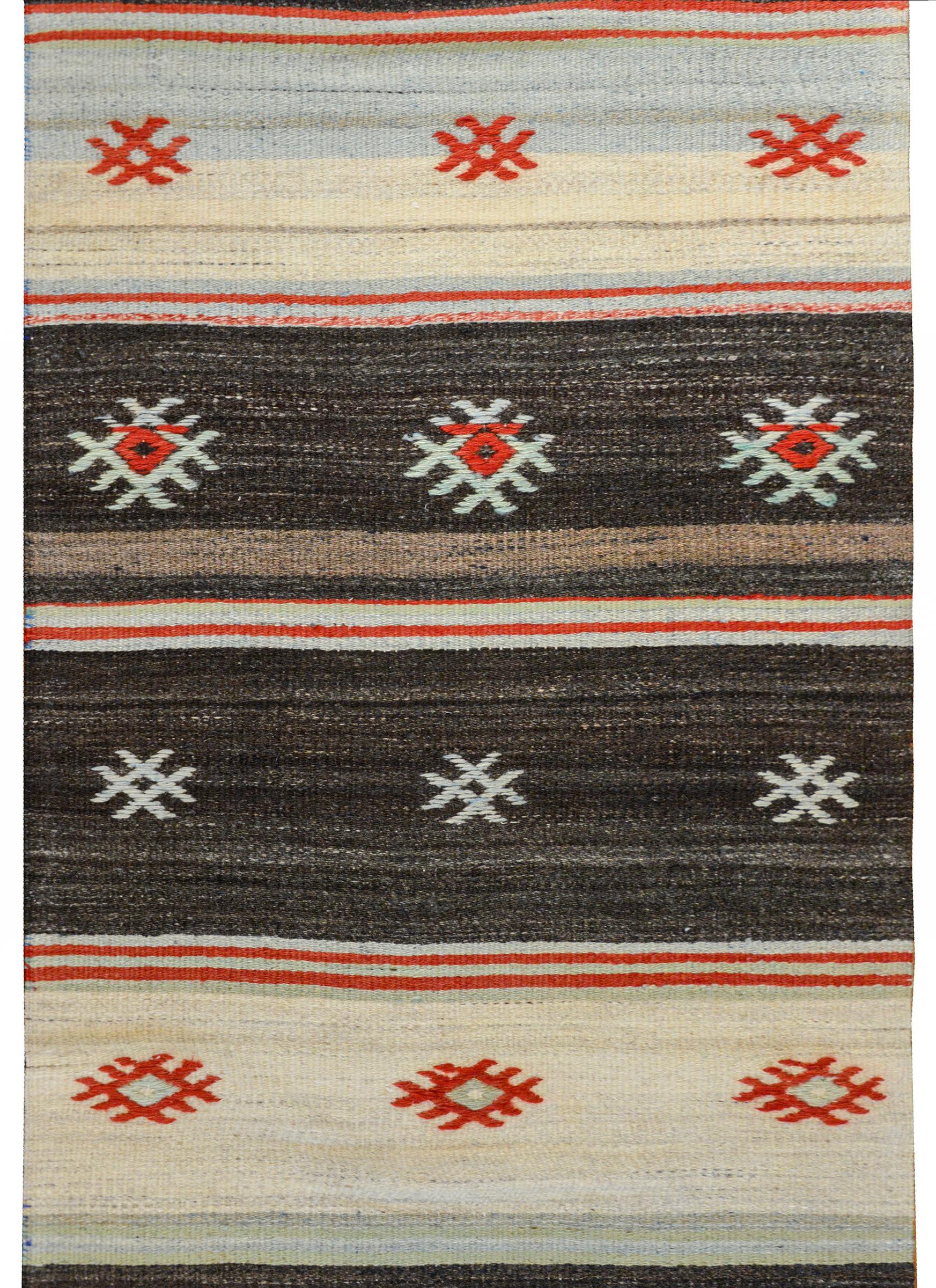 A vintage Turkish Konya Kilim runner with a wonderful black, white, crimson, pale indigo, pale green, and cream striped pattern with embroidered stylized flowers.
