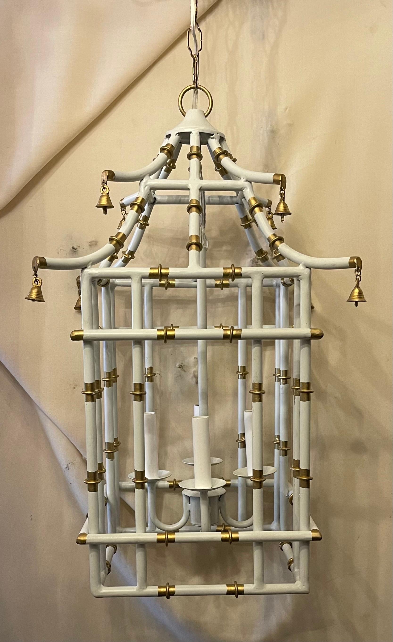 A wonderful painted white & gold gilt pagoda bamboo form chinoiserie lantern fixture with 4 candelabra light cluster each taking up to a 40 watt bulb.
Rewired and ready to install with chain canopy and mounting hardware.