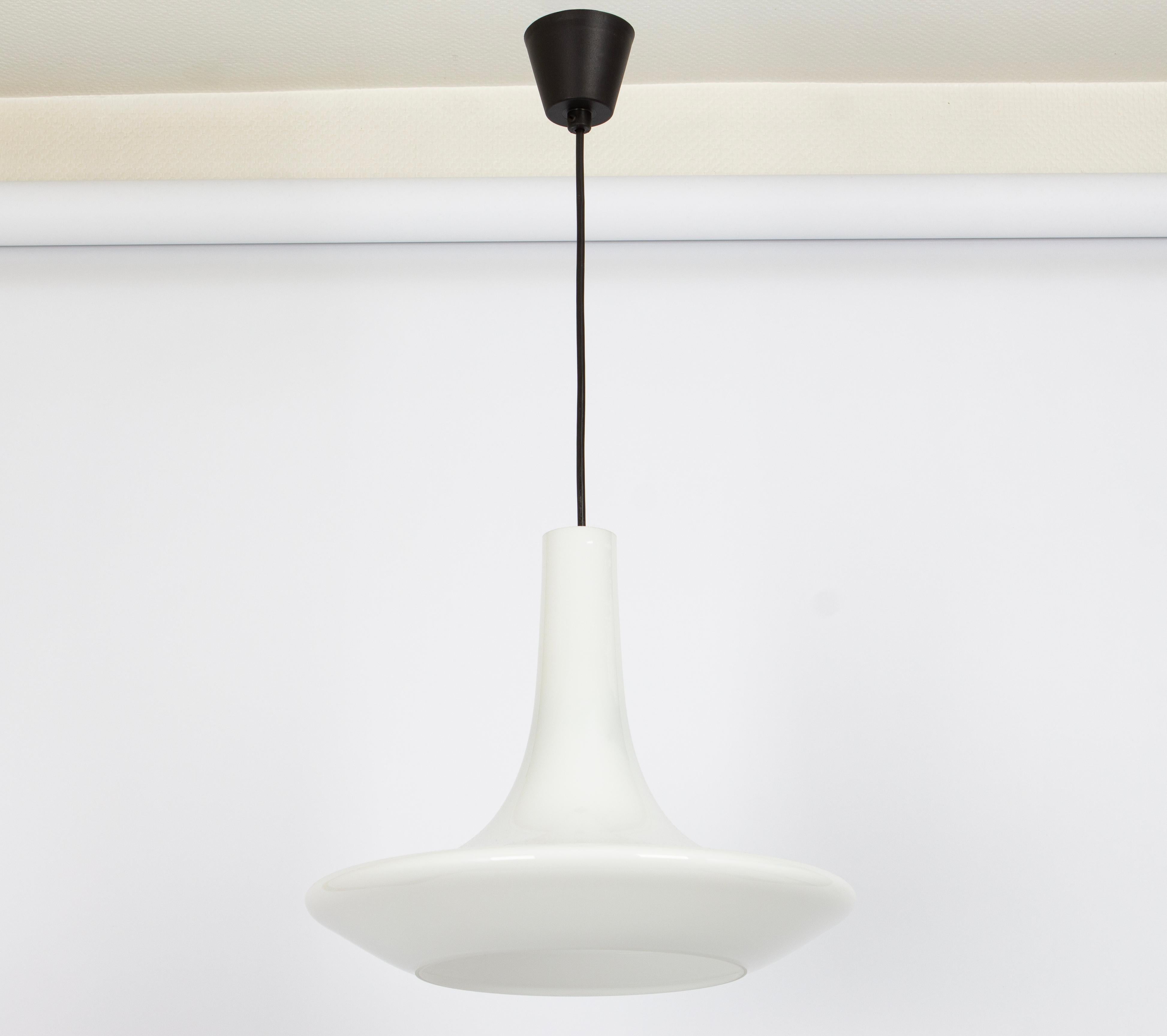 A special form of opal glass pendant designed by Koch & Lowy for Peill & Putzler, manufactured in Germany, circa 1970s.
White color opal glass.

Sockets: One x E27 standard bulb. (150 W max).
Drop rod can be adjusted as required, free of charge, for