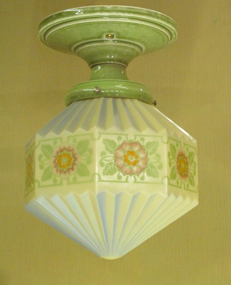 We just don't see many examples from the 1920s that rise to the bold exuberance displayed on the expertly painted (and fired on) design on the globe. Very hard to find Bungalow Green porcelain fitter by Alabax.
Rewired to UL standards and comes with