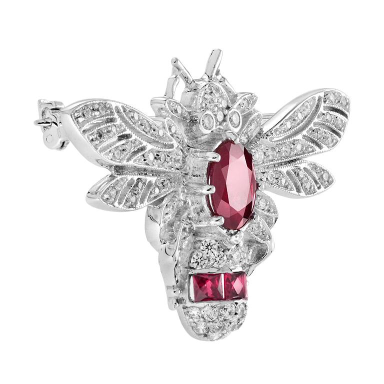 This brooch is bejeweled in a vibrant tone of ruby and brilliant diamond in a white gold setting. Embellish your outfit with a sweetly significant bee motif. 

Information
Metal: 14K White Gold
Width: 43 mm.
Length: 30 mm.
Weight: 9.22 g. (approx.