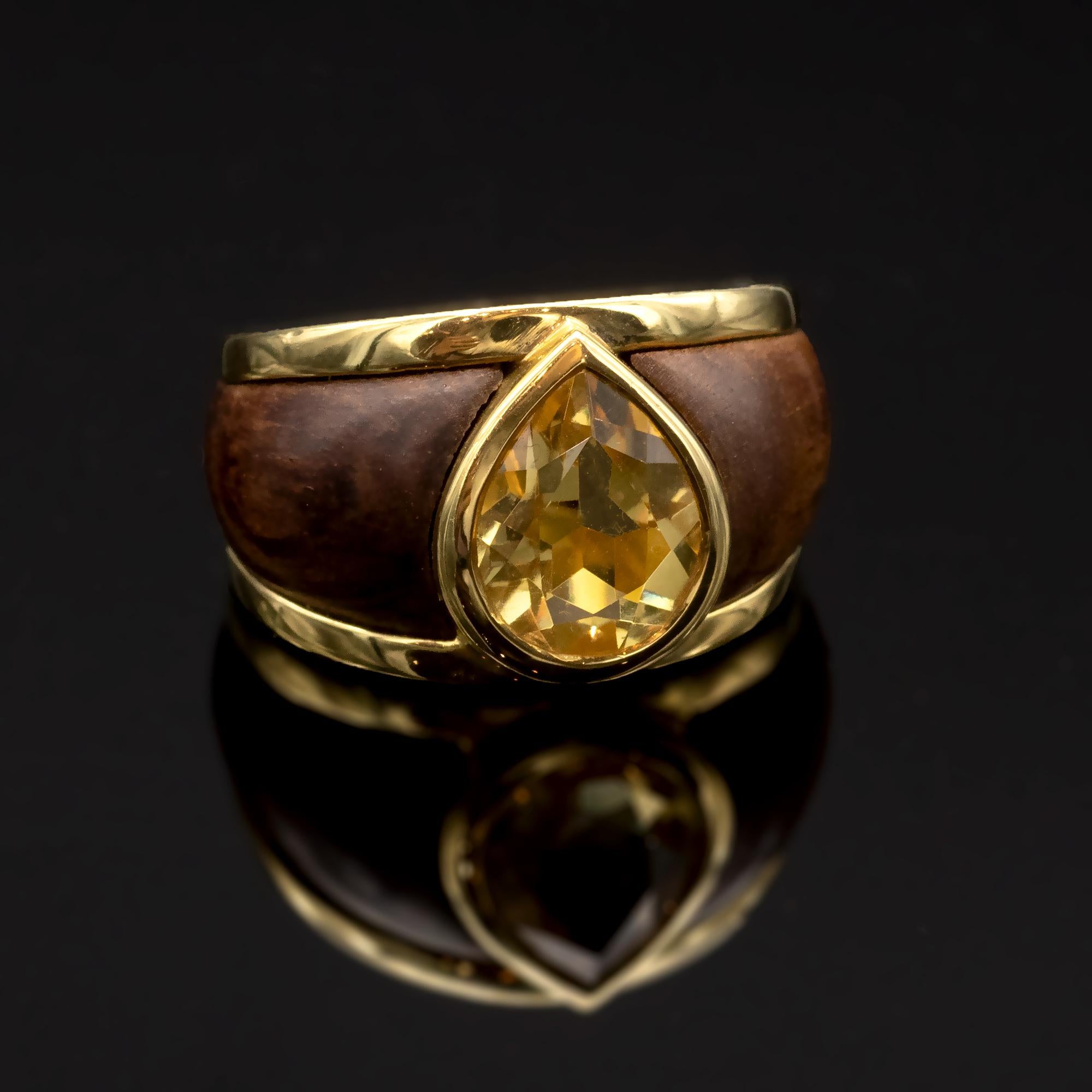 Exquisite wood and 18 karat gold ring. Set with a pear shaped citrine. Slightly domed wood bands are inlayed in the shank. 
Modern design jewellery is more difficult to achieve that it seems as it needs perfection in both proportions and make.  Both