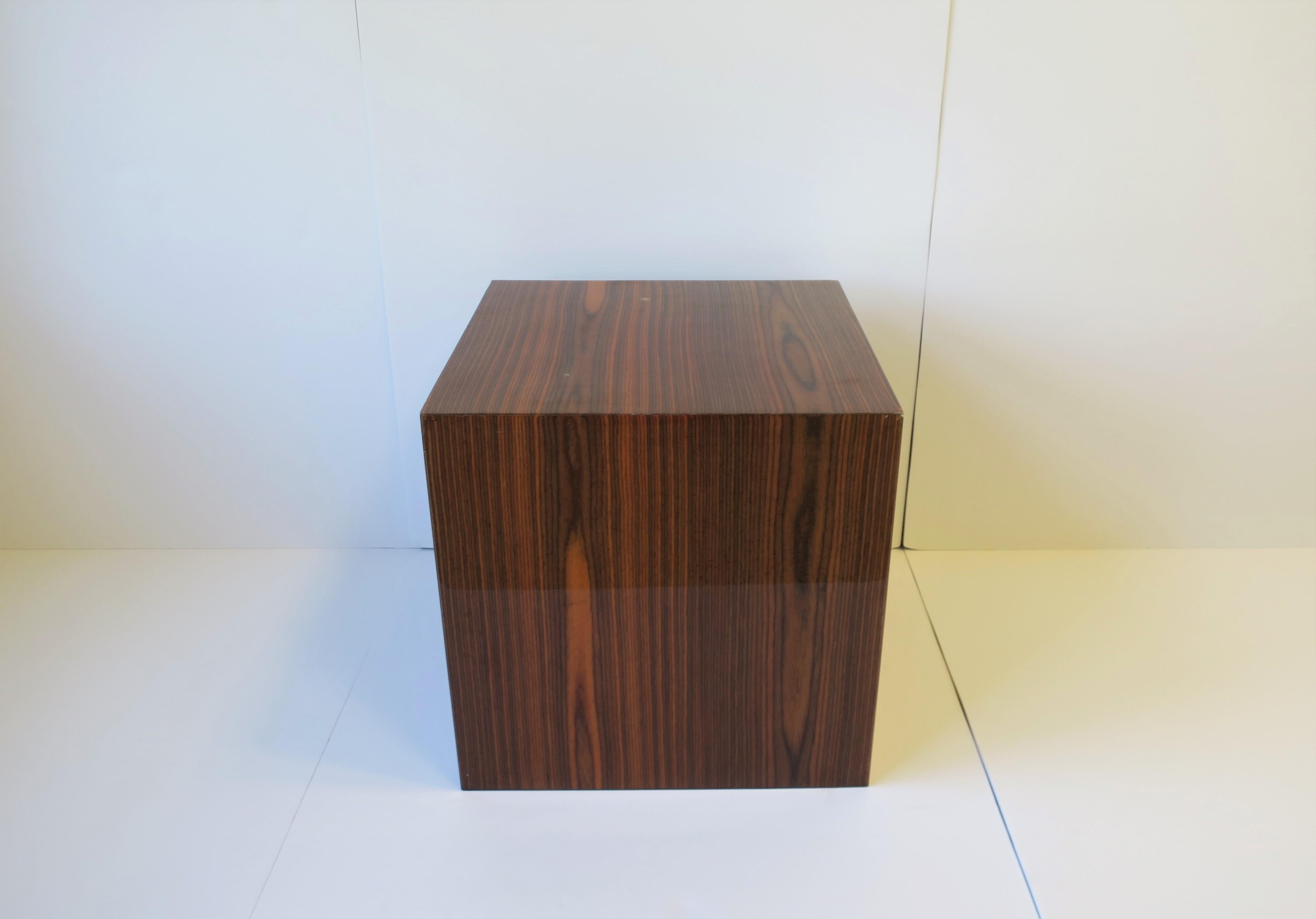 A wood and acrylic pedestal table, circa 21st century. Table is veneered in a rich brown wood and coated with clear acrylic. Great as end table, nightstand table, or to hold/display sculpture, drinks table, etc. Dimensions: 18