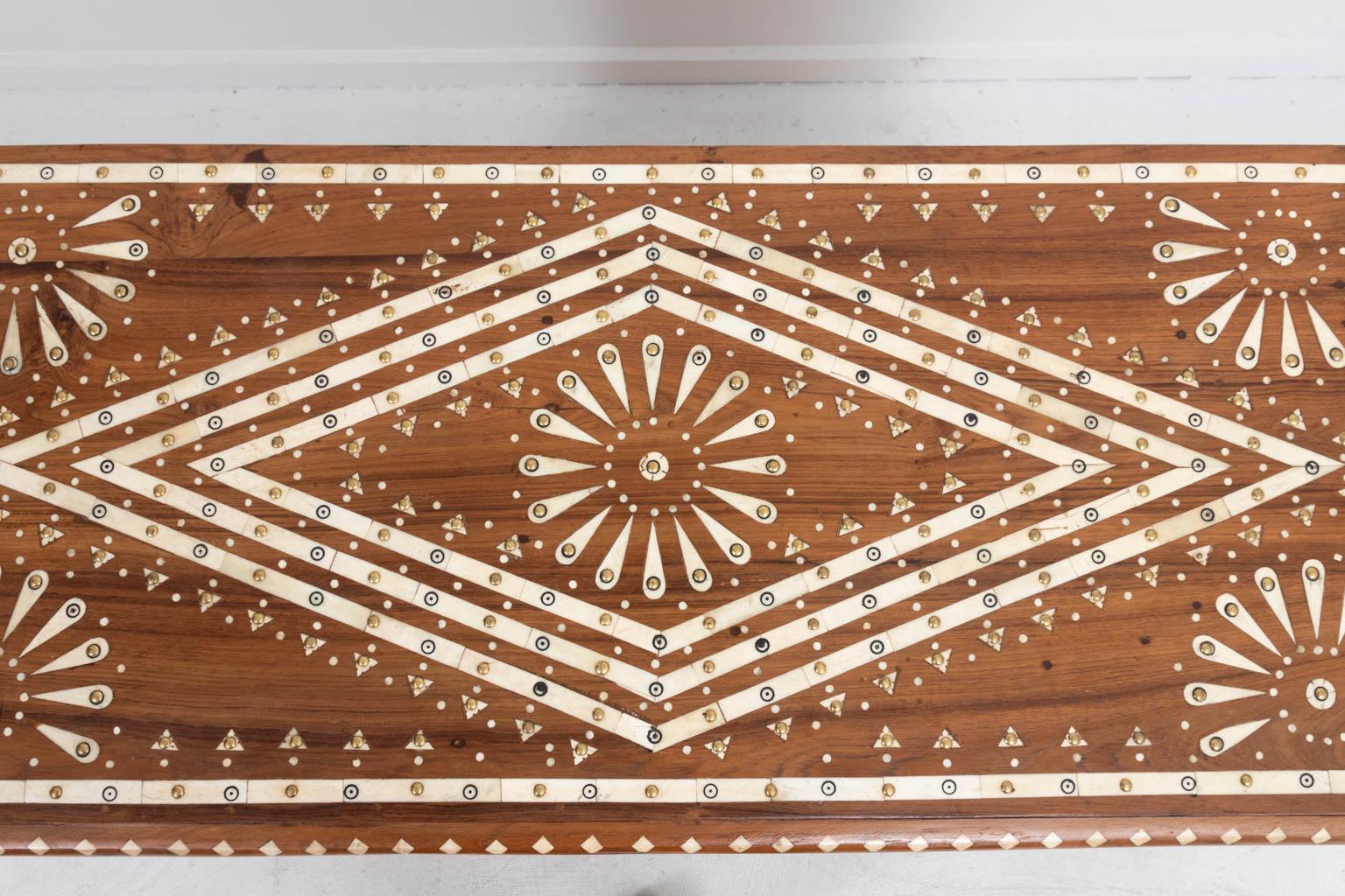 Wooden eight-drawer chest with geometric bone inlay throughout. The piece also features metal studded detail. Please note of wear consistent with age.