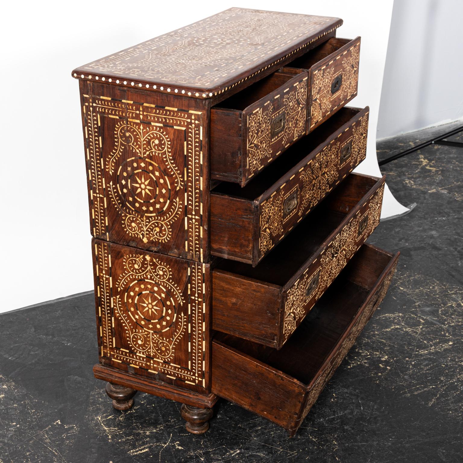 Wood and bone inlaid campaign chest with geometric detail throughout. The piece also features metal hardware. Please note of wear consistent with age including minor finish loss along with minor oxidation and patina to the metal hardware.