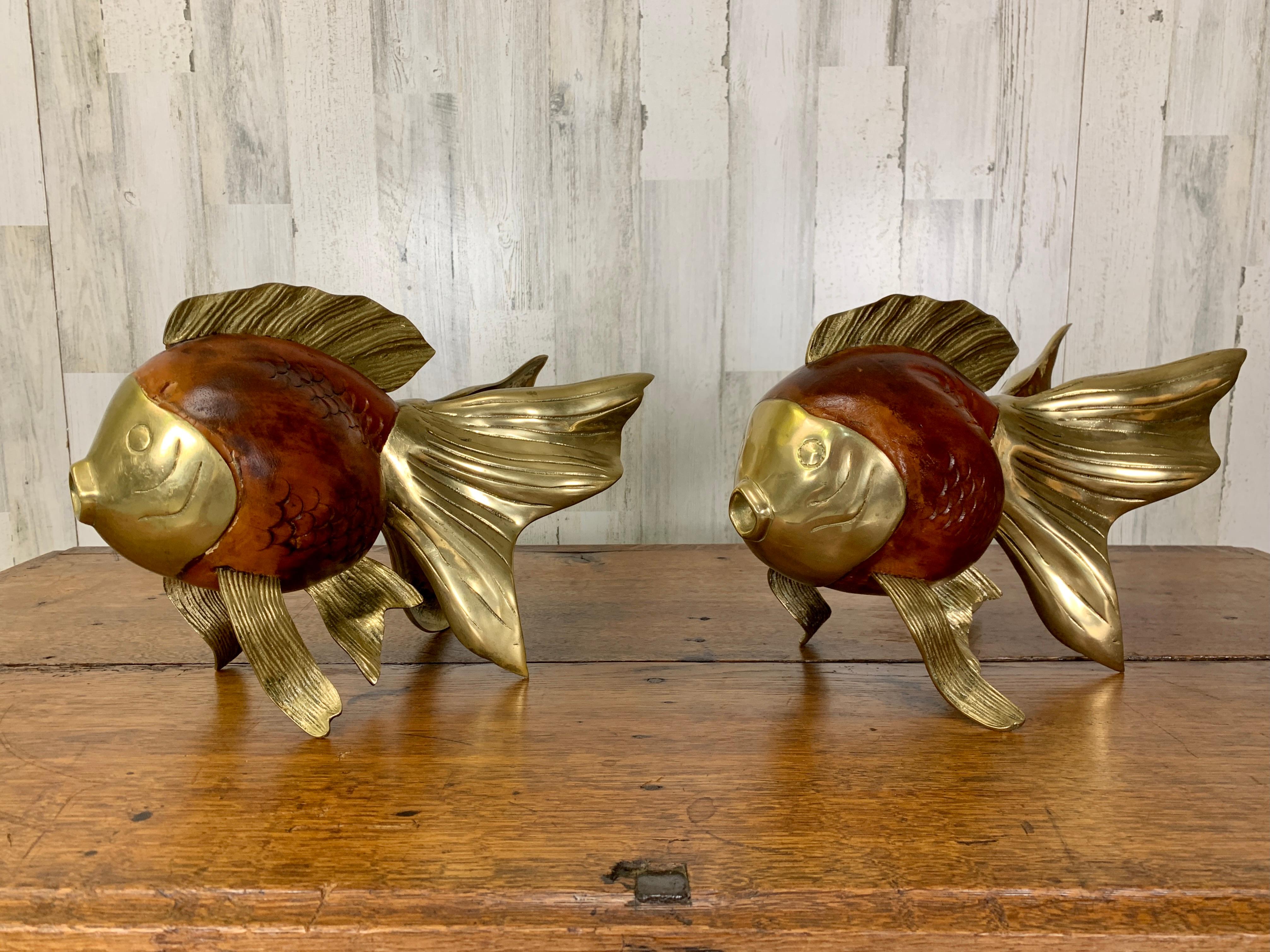 Vintage decorative koi fish sculptures. Hand shaped and carved wood with brass accents.