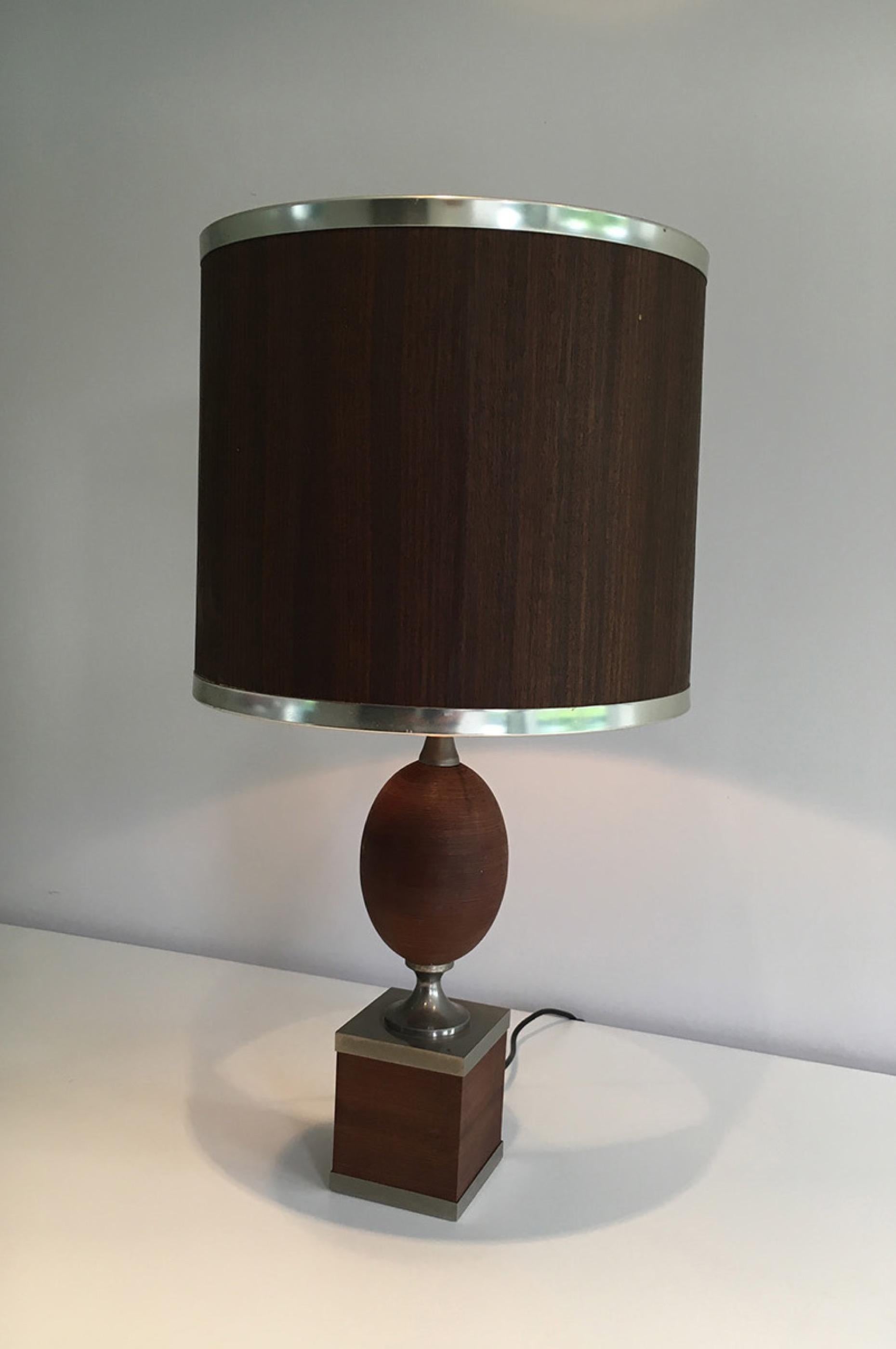 This very nice and rare egg table lamp is made of wood and brushed steel with a thin wooden shade. This is a beautiful French work, in the style of Philippe Barbier, circa 1970.