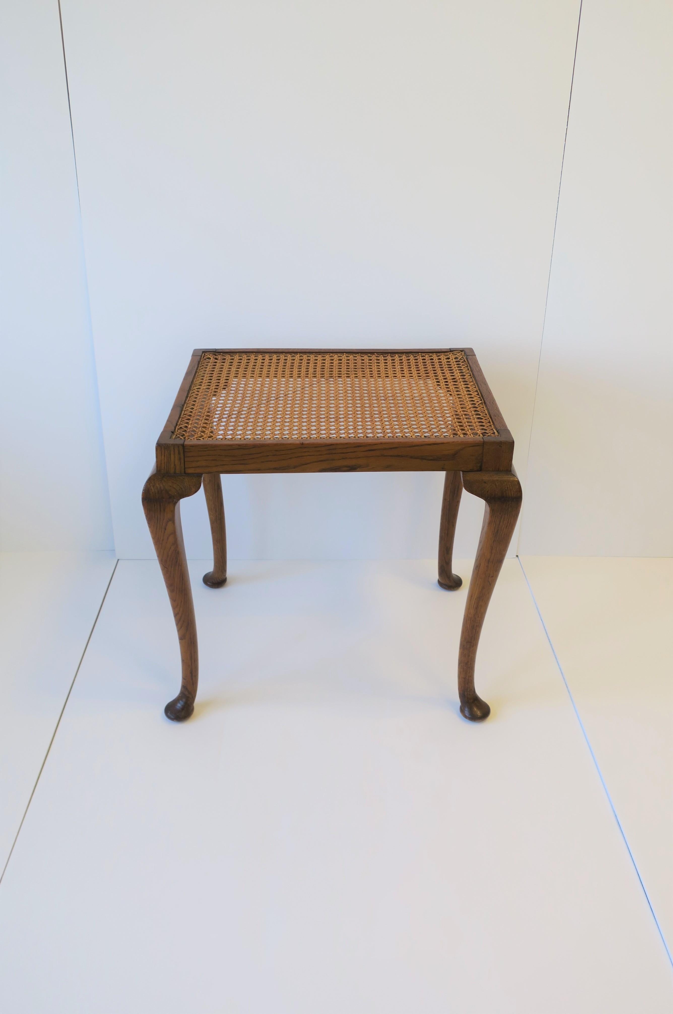 A beautiful rectangular wicker cane top and oak wood frame side or end table in the Queen Anne style with cabriole leg and pad feet, circa early to mid-20th century, Europe. Cane in very good condition as show in images. Table can be positioned two