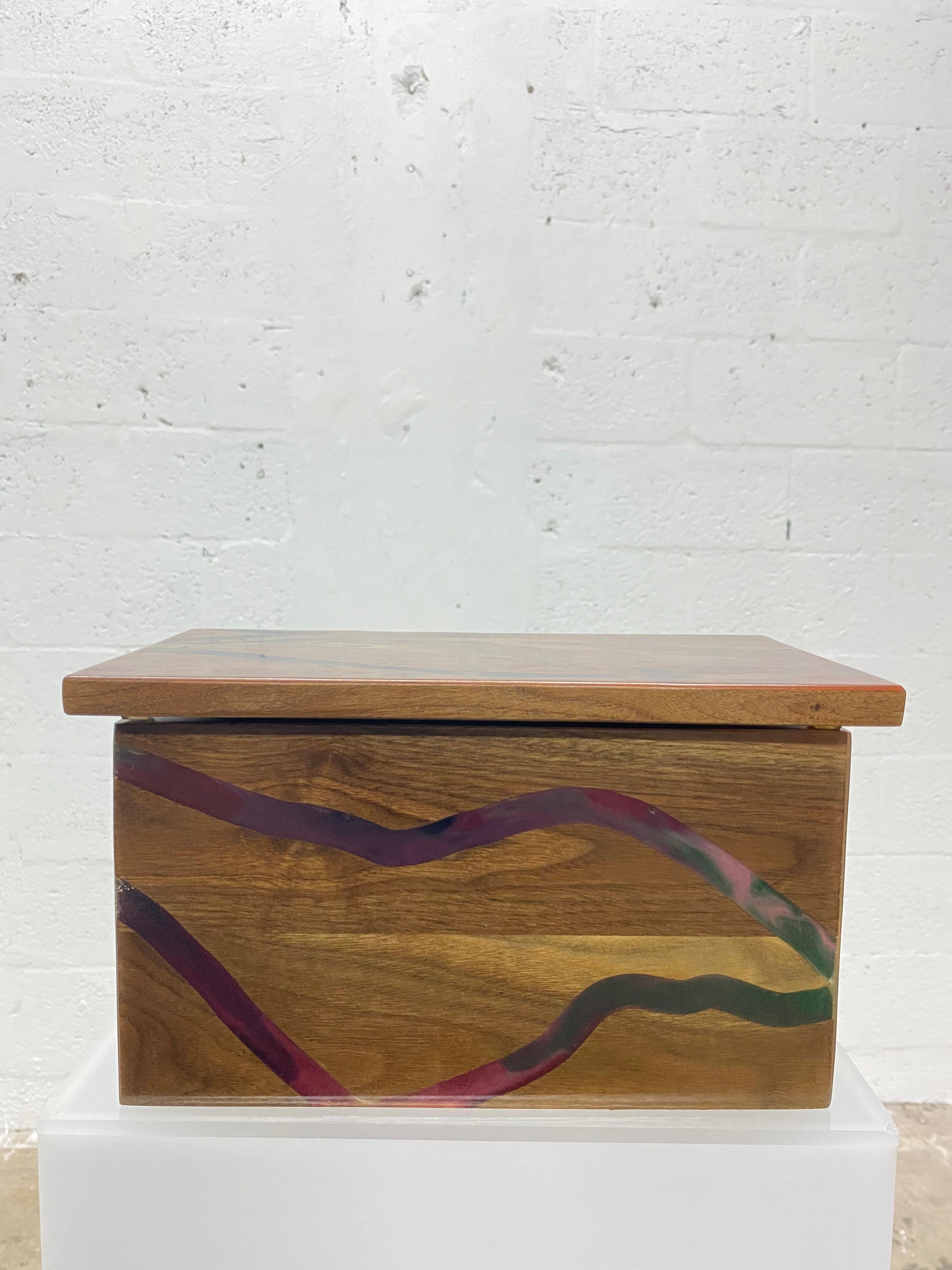 Beautiful wood and colored resin channeled storage box with brass hinge.