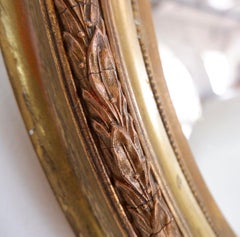 Wood and gilded plaster "Noeud d'Amour" Oval mirror