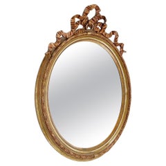 Wood and gilded plaster "Noeud d'Amour" Oval mirror