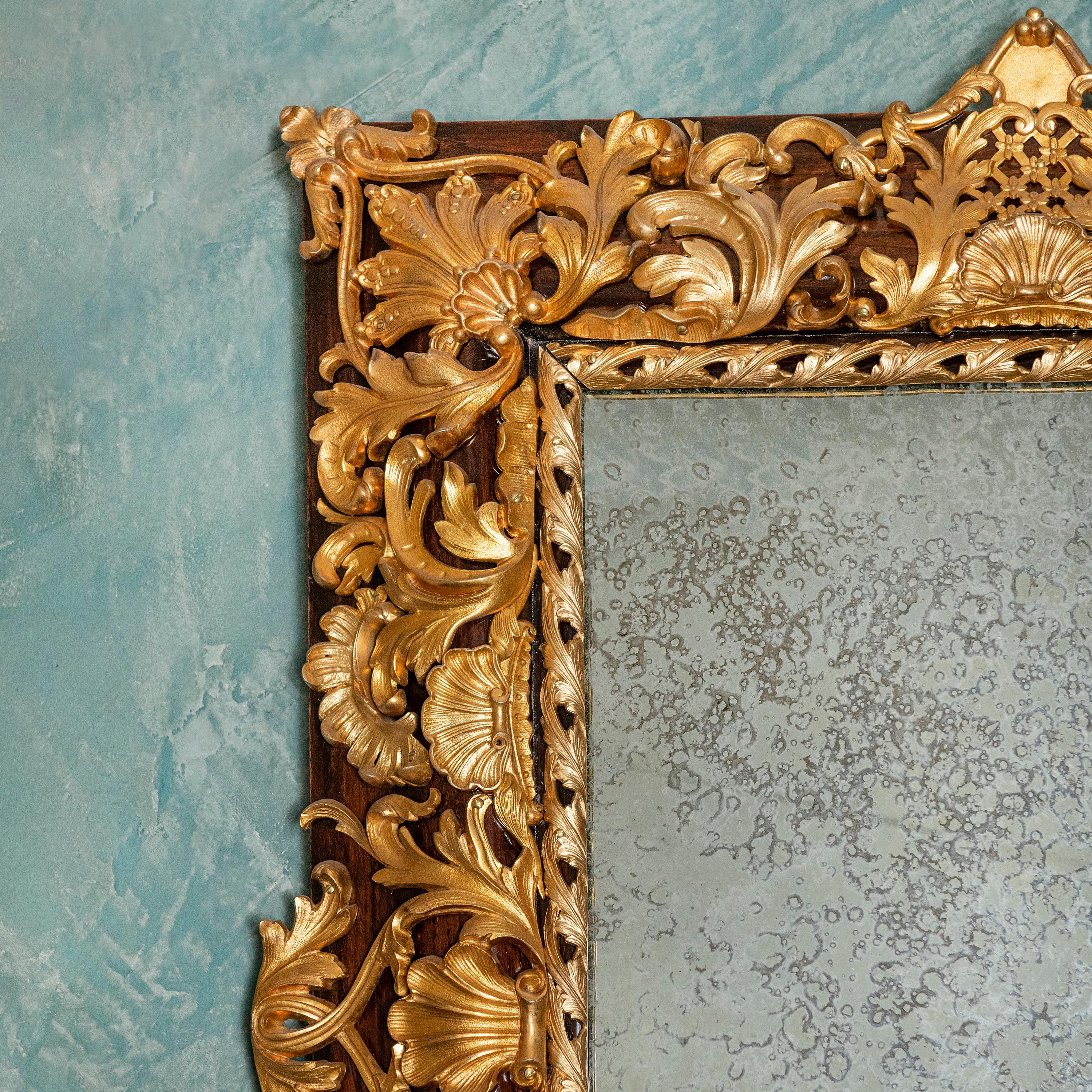 Wood and gilt bronze wall mirror, France, late 19th century.