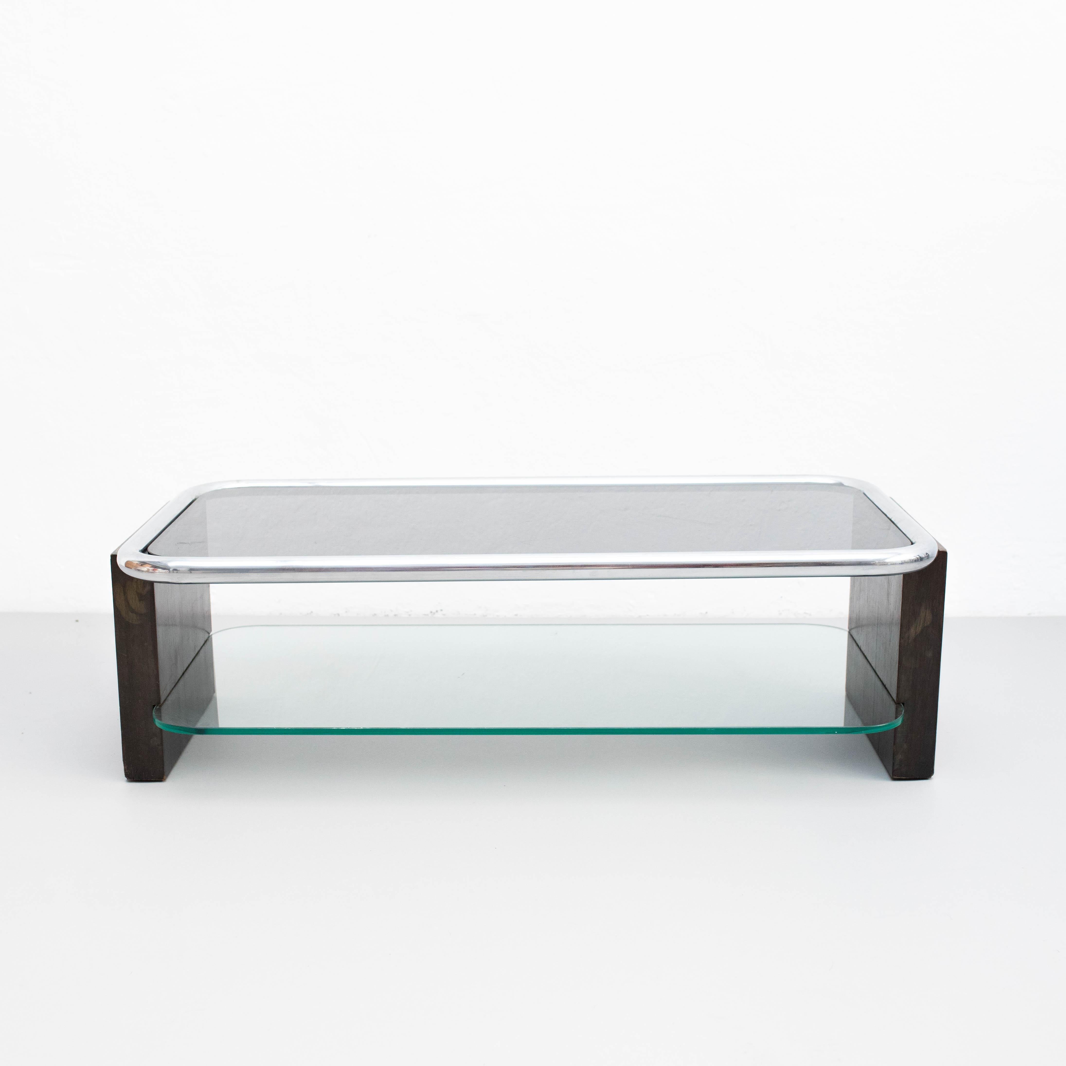 Couchtisch, um 1950.  Von unbekanntem Hersteller, aus Spanien.    Im Originalzustand, mit einigen sichtbaren Gebrauchs- und Altersspuren, die eine schöne Patina erhalten haben.    MATERIALIEN:  Holz  Glas.    Abmessungen:  H 36 cm  W 113.5 cm  D 55