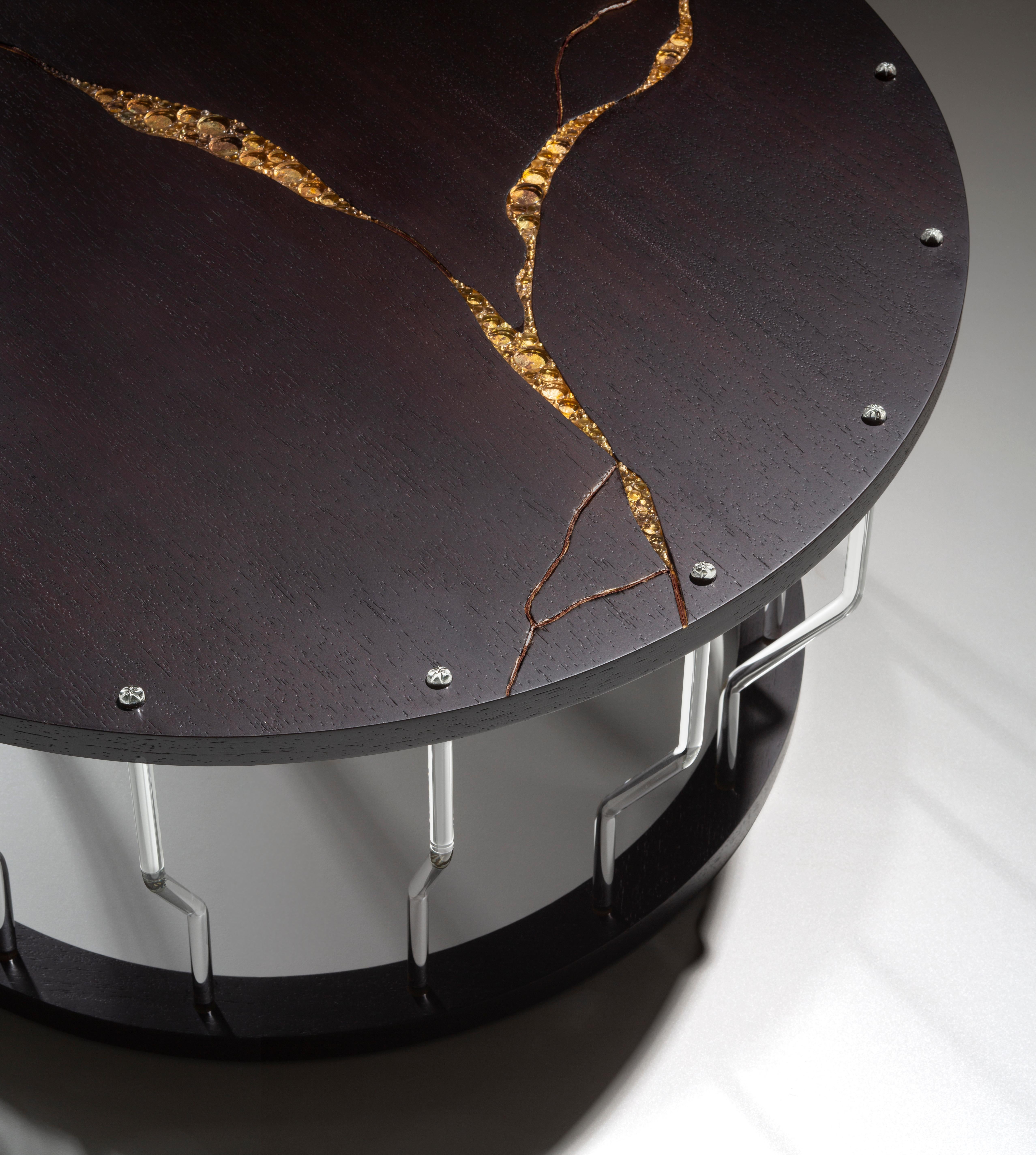 Constellation wood and glass coffee table handmade by Giordano Viganò and Simone Crestani.
In this coffee table, we used glass and oxidized gold leaf as inlay to create a decoration that reminds a constellation. The top in Wenge wood is supported