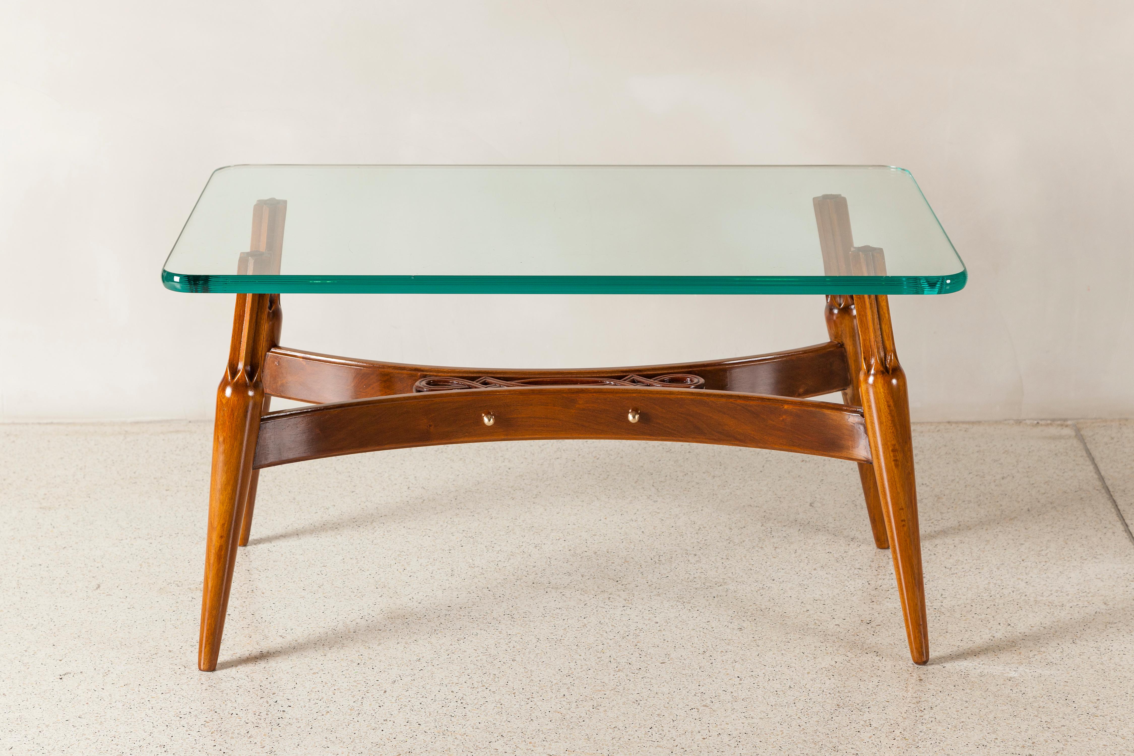 Wood and glass low table by Englander & Bonta, Argentina, circa 1950. 
Glass dimensions: 2 cm height, 80 cm width, 50 cm depth.
Dimensions of the wood base: 42 cm height, 77 cm width, 38 cm depth.