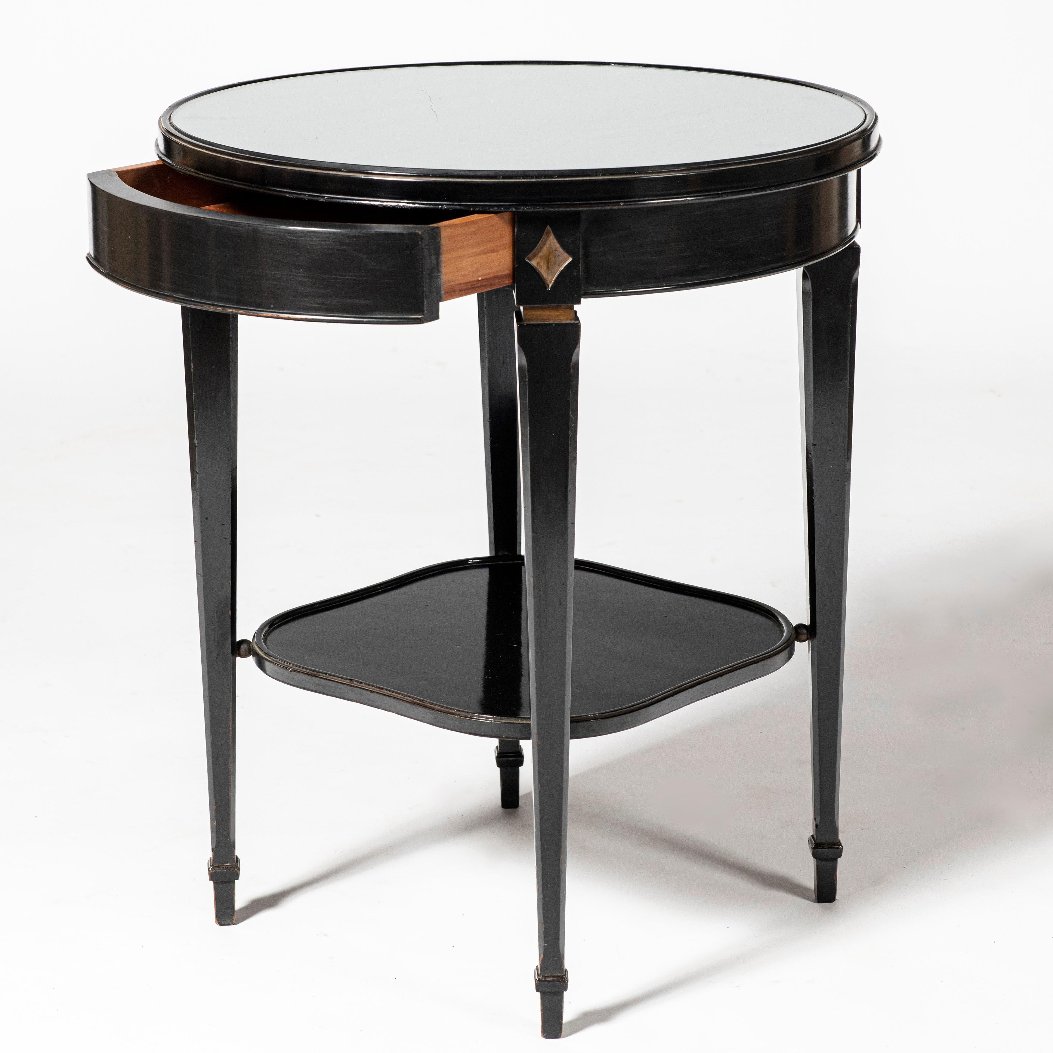 Wood and glass round table attributed to Maison Jansen, France, circa 1940.