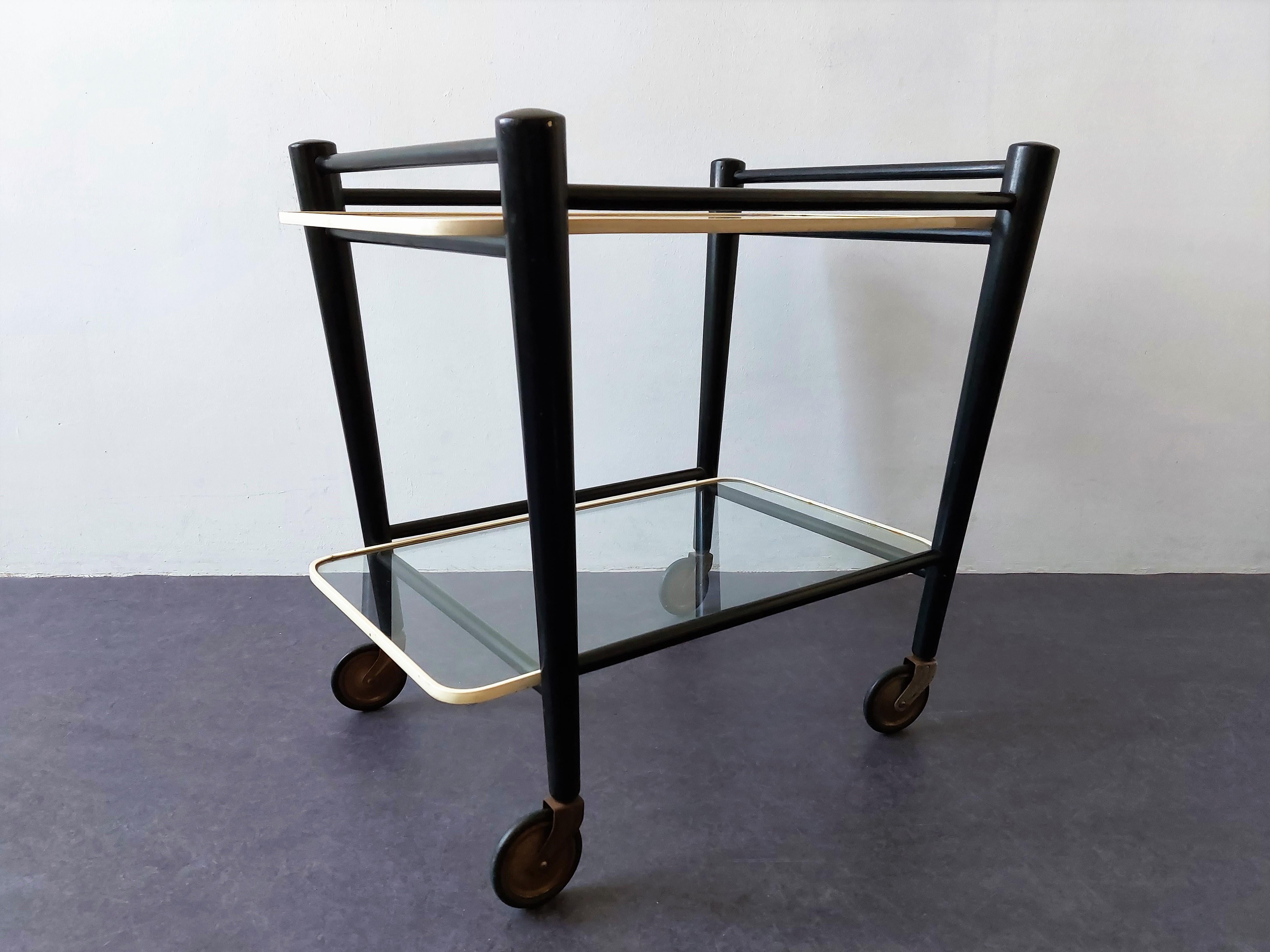 This stunning trolley, originally intended as a tea serving trolley, was designed for the former Dutch furniture manufacturer Coja in Culemborg in the late 1950's or early 1960's. The trolley is often (wrongly) assigned to Pastoe. It has a solid