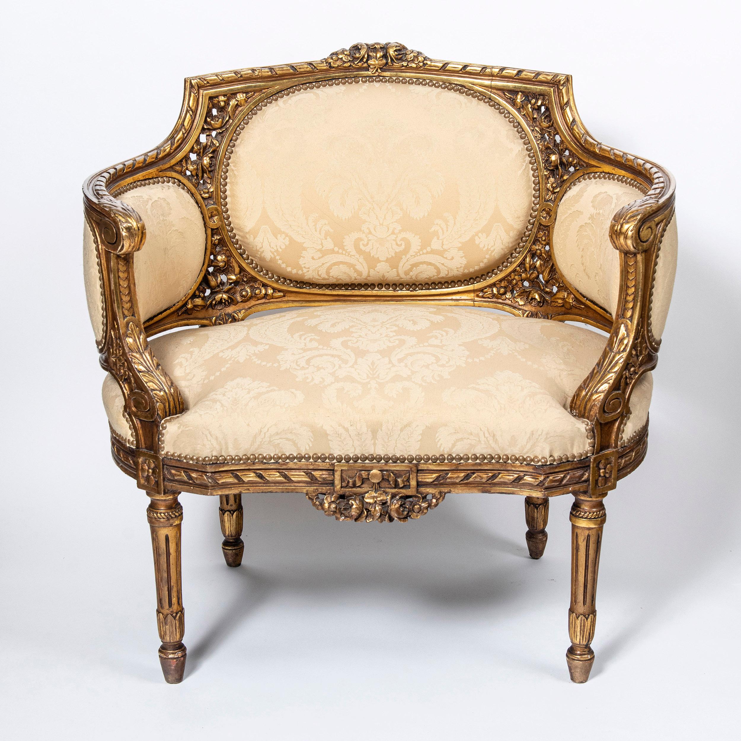 Wood and gold leaf three piece suite. France, late 19th century.
Attributed to Maison Jansen.

Dimensions:
Large sofa: 91 cm height, 137 cm width, 67 cm depth, 48 cm seat height.
Side chairs: 82 cm height, 80 cm width, 60 cm depth, 40 cm seat