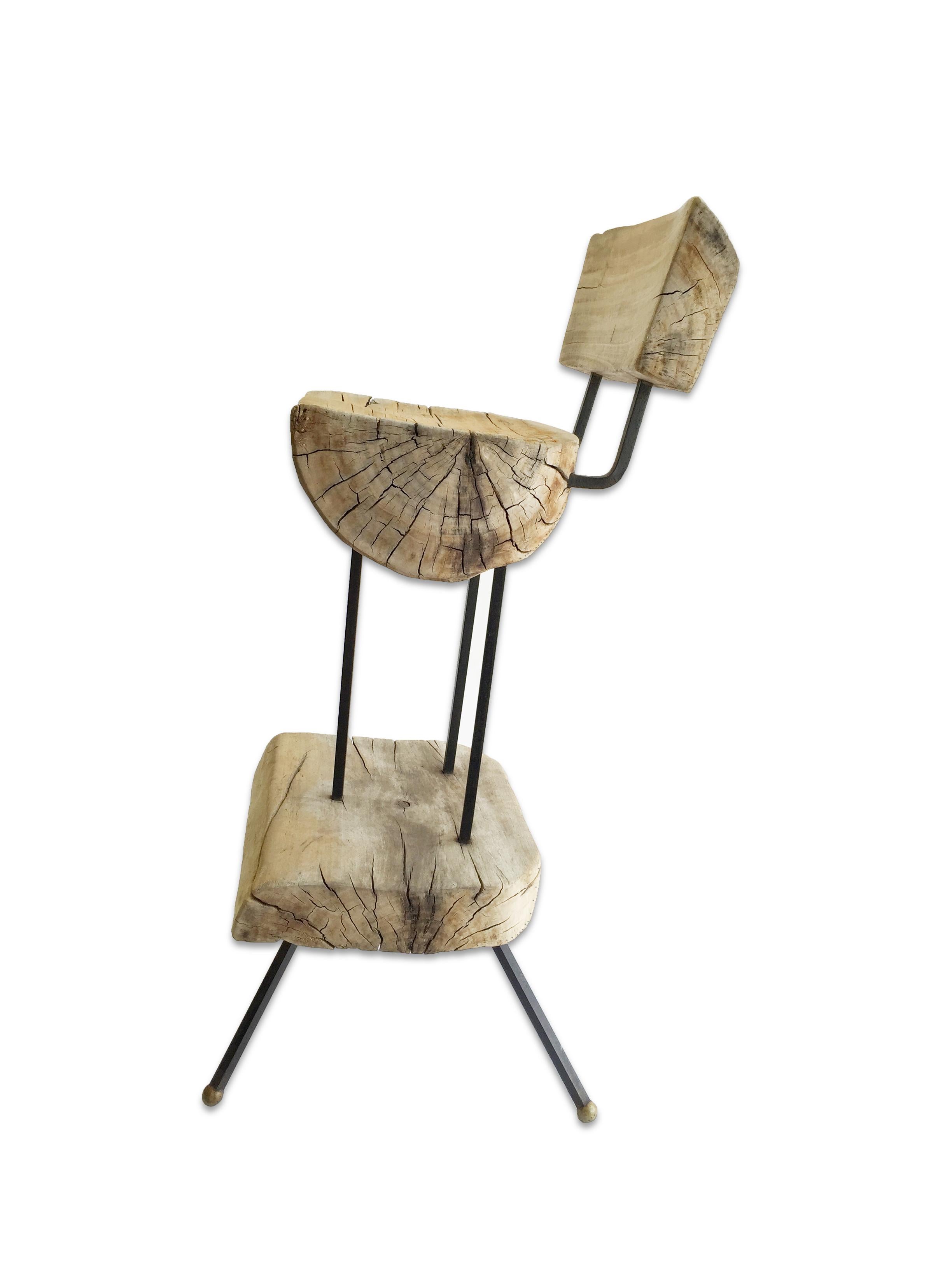 This wood and iron bar stool was made by Sabena in Mexico circa 1950s. The stool is composed of an iron frame and  a split log seat and back. This unique piece is in excellent condition. 

Property from esteemed interior designer Juan Montoya. Juan