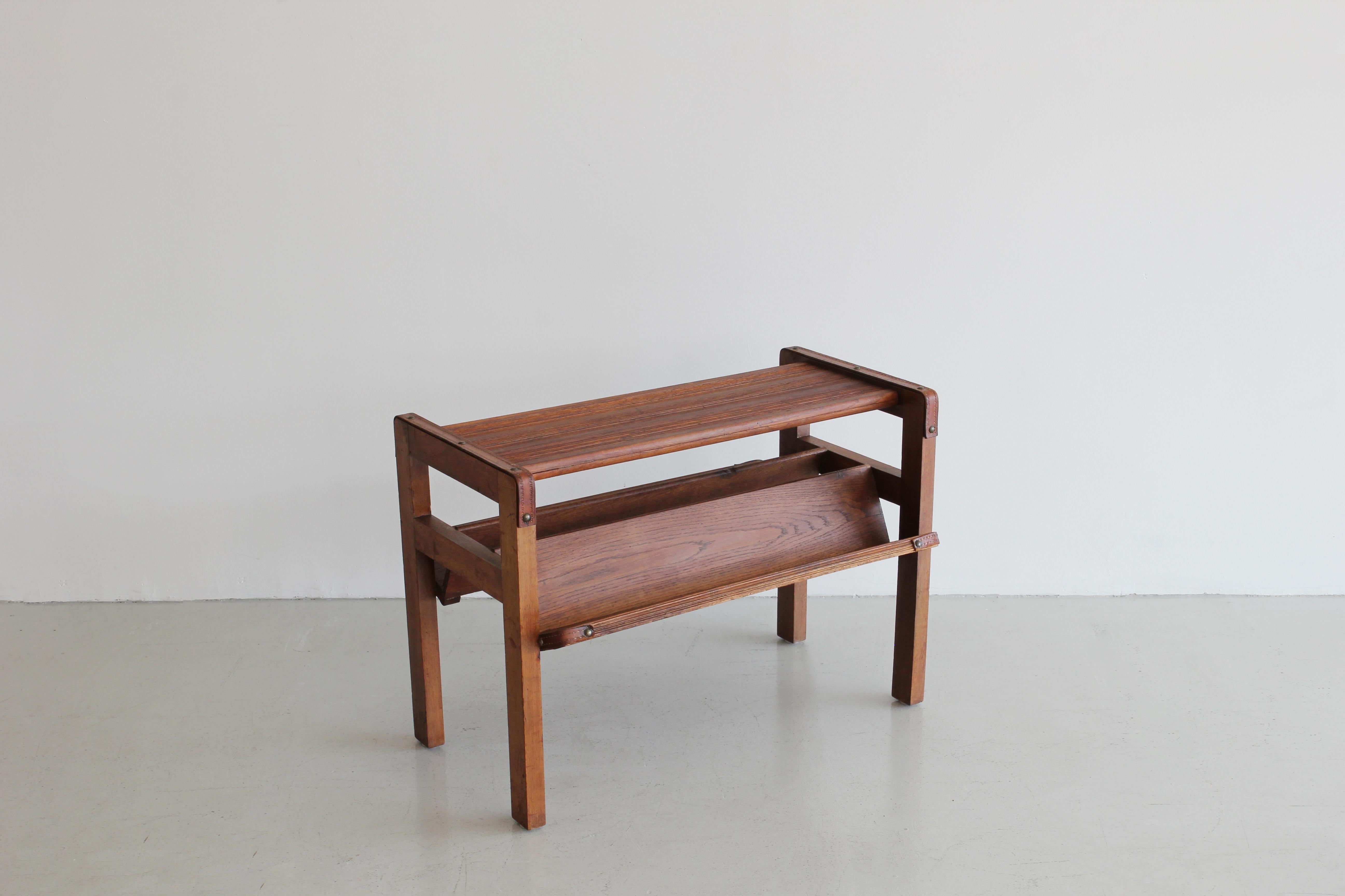 Handsome oak magazine table by Jacques Adnet. Rectangular form with slatted grooved top, inverted 