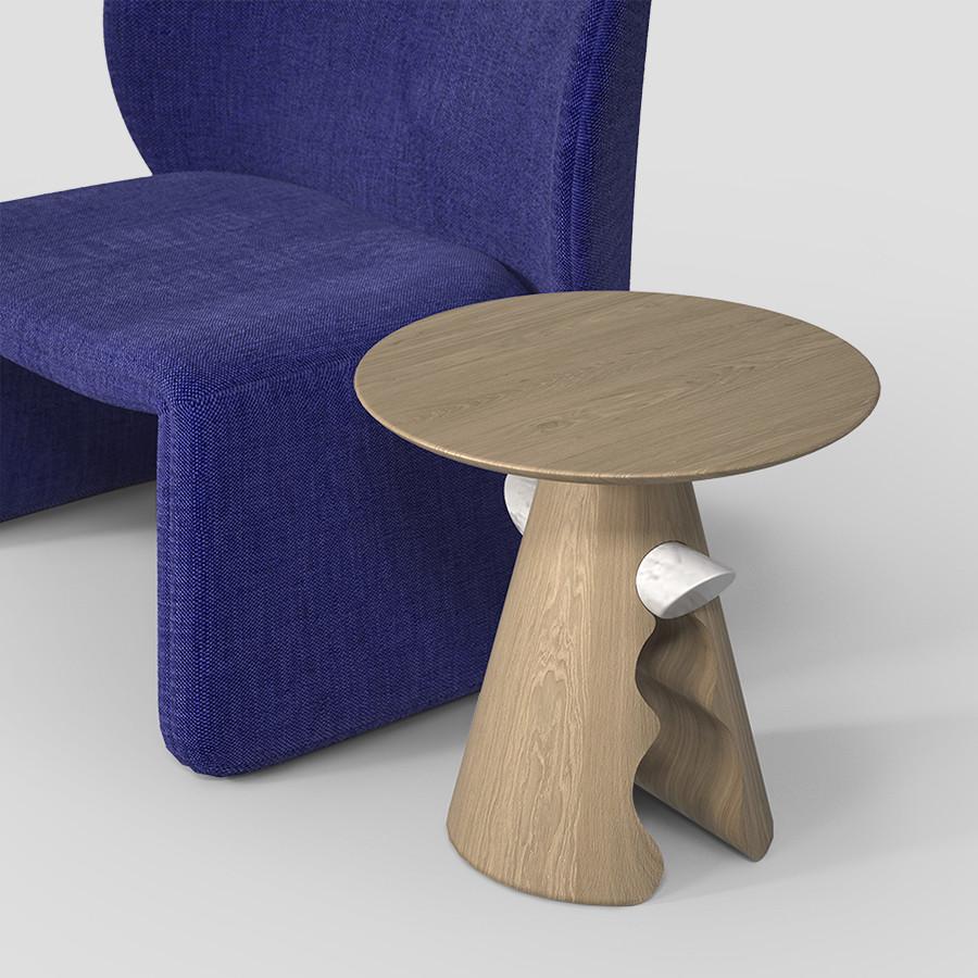 Conçu par Unicuo, Cracker allie la fluidité de ses courbes à la solidité du bois, créant une base conique qui s'élève de l'intérieur avec des formes douces et ondulées, se terminant par un cercle parfait qui accueille un bar en marbre. Ce cercle
