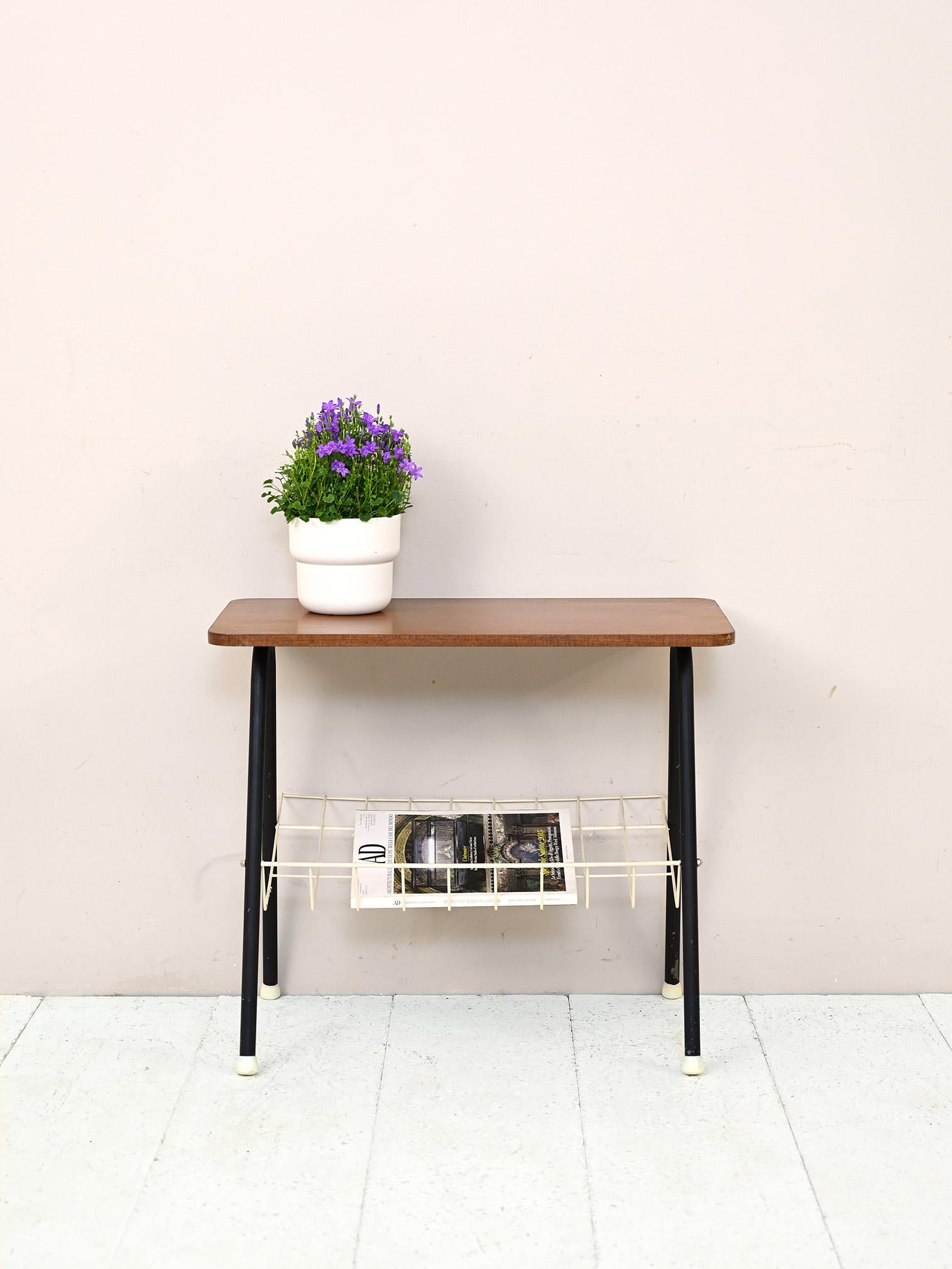 Scandinavian 1960s modern antique sofa table.

A piece of furniture with modern lines and strong character. Featuring black-painted tubular metal legs and a white metal magazine rack top.
The teak top, rectangular and with rounded corners, lends