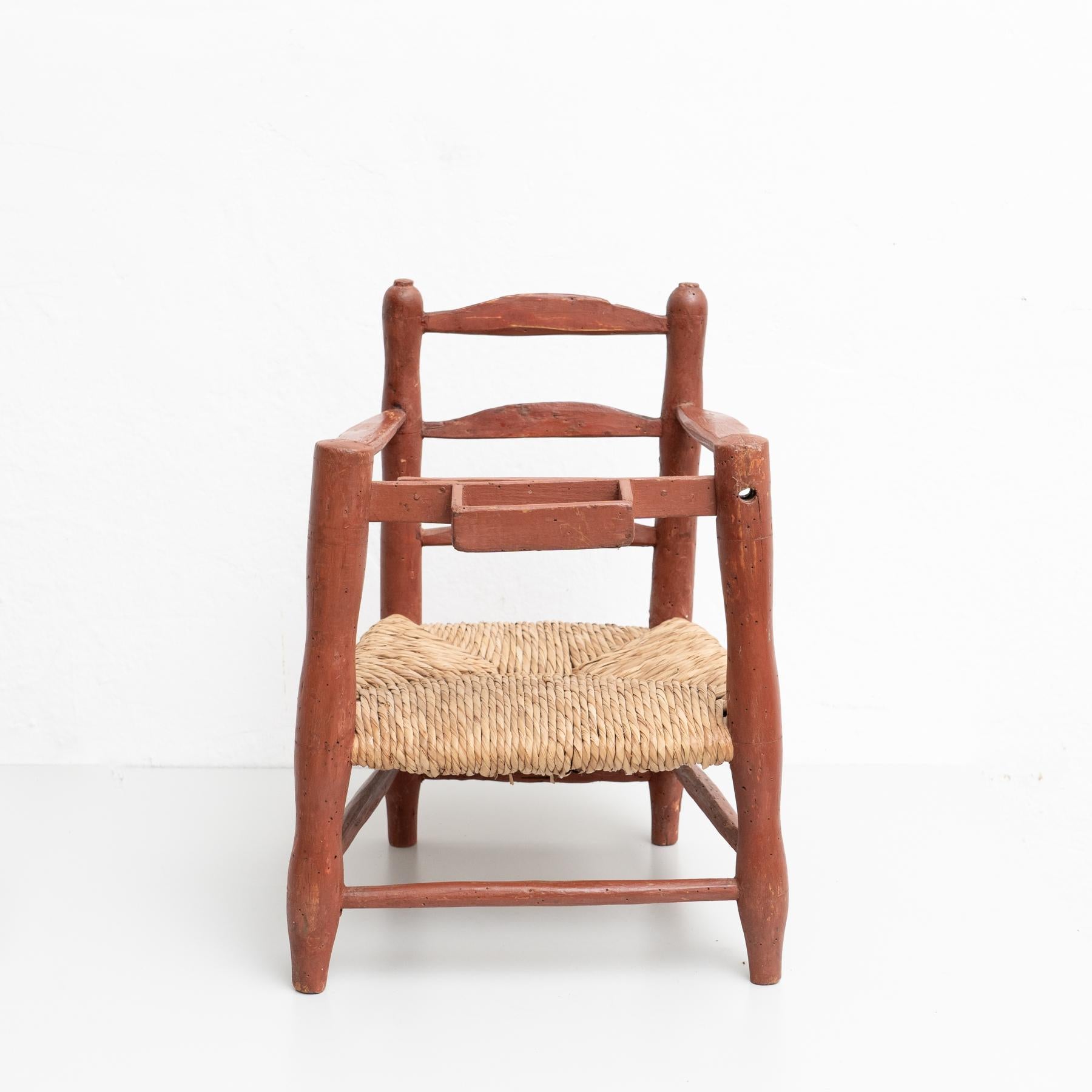 Antique traditional Spanish wood and rattan children chair.

Made by unknown manufacturer, Spain, circa 1960. 

In original condition, with minor wear consistent with age and use, preserving a beautiful patina.

Materials:
Wood
Rattan.
 