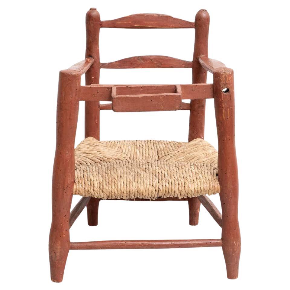 Antique traditional Spanish wood and rattan children chair.

Made by unknown manufacturer, Spain, circa 1960. 

In original condition, with minor wear consistent with age and use, preserving a beautiful patina.

Materials:
Wood
Rattan.
 