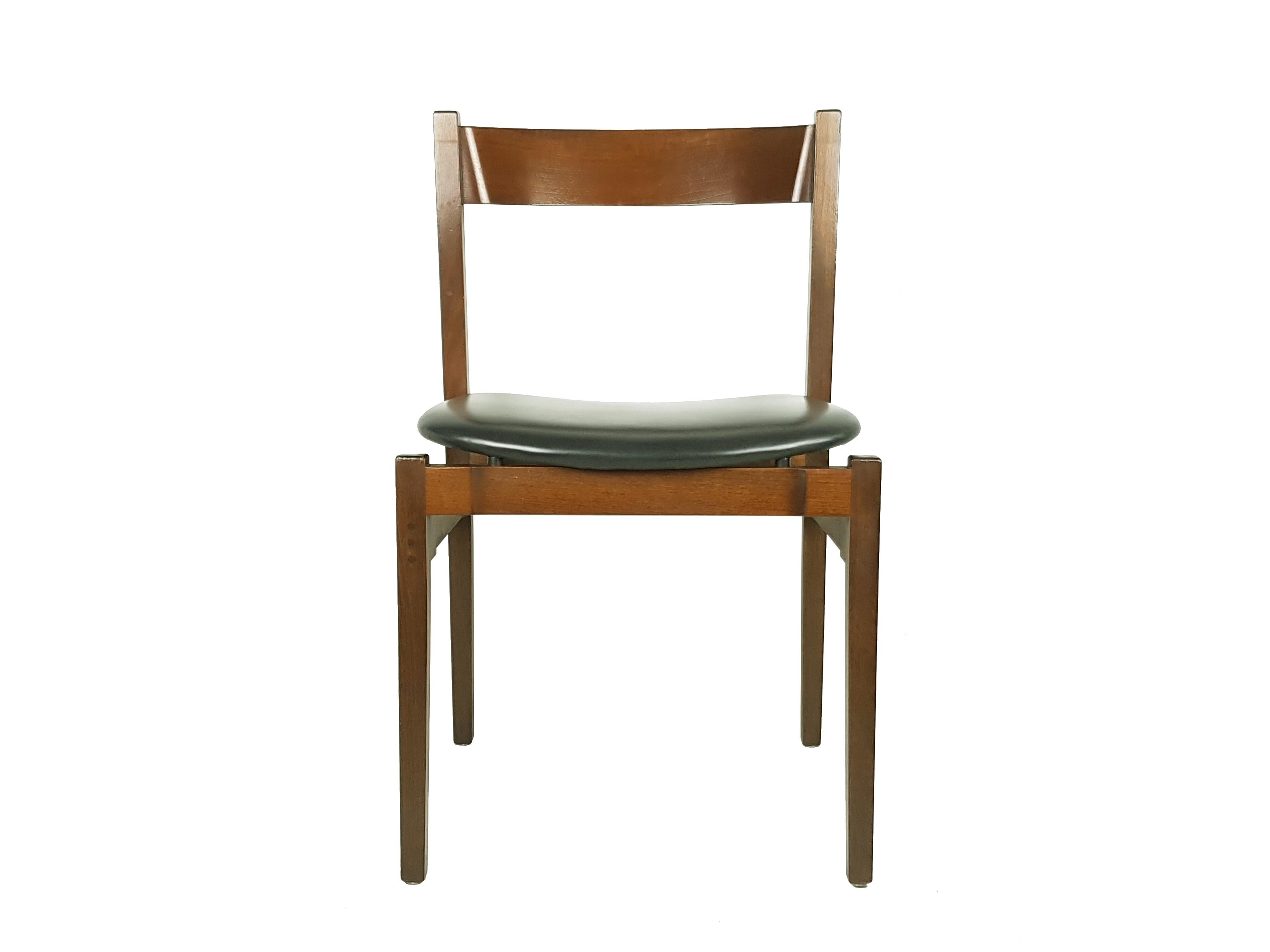 Set of 6 dining chairs designed by Gianfranco Frattini for Cassina in the '60s. Walnut structure with black skai seat. Very good condition: the chairs have been refinished, but show light signs of wear consistent with age and use. The filling of the