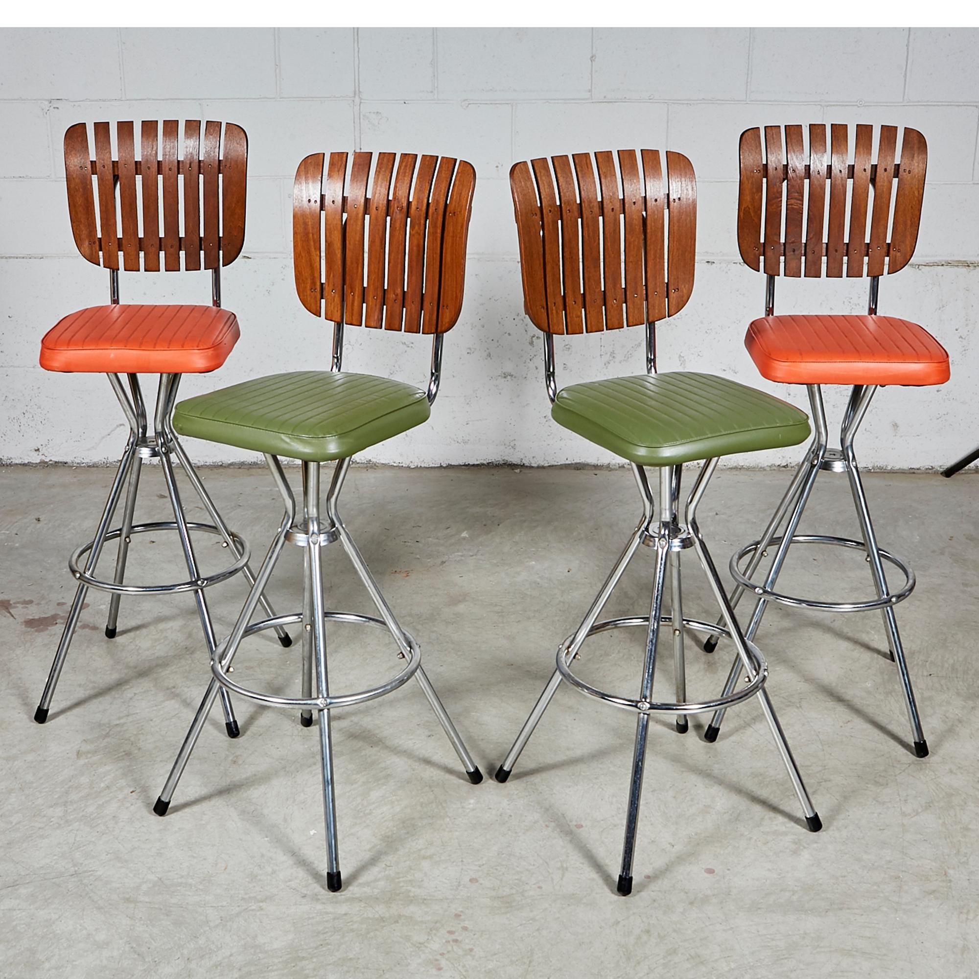 Vintage 1960s set of four high back bar stools with orange and green vinyl seats on a chrome base. In newly refinished condition. Measure: Seat, 29.5 in H. No maker's mark.