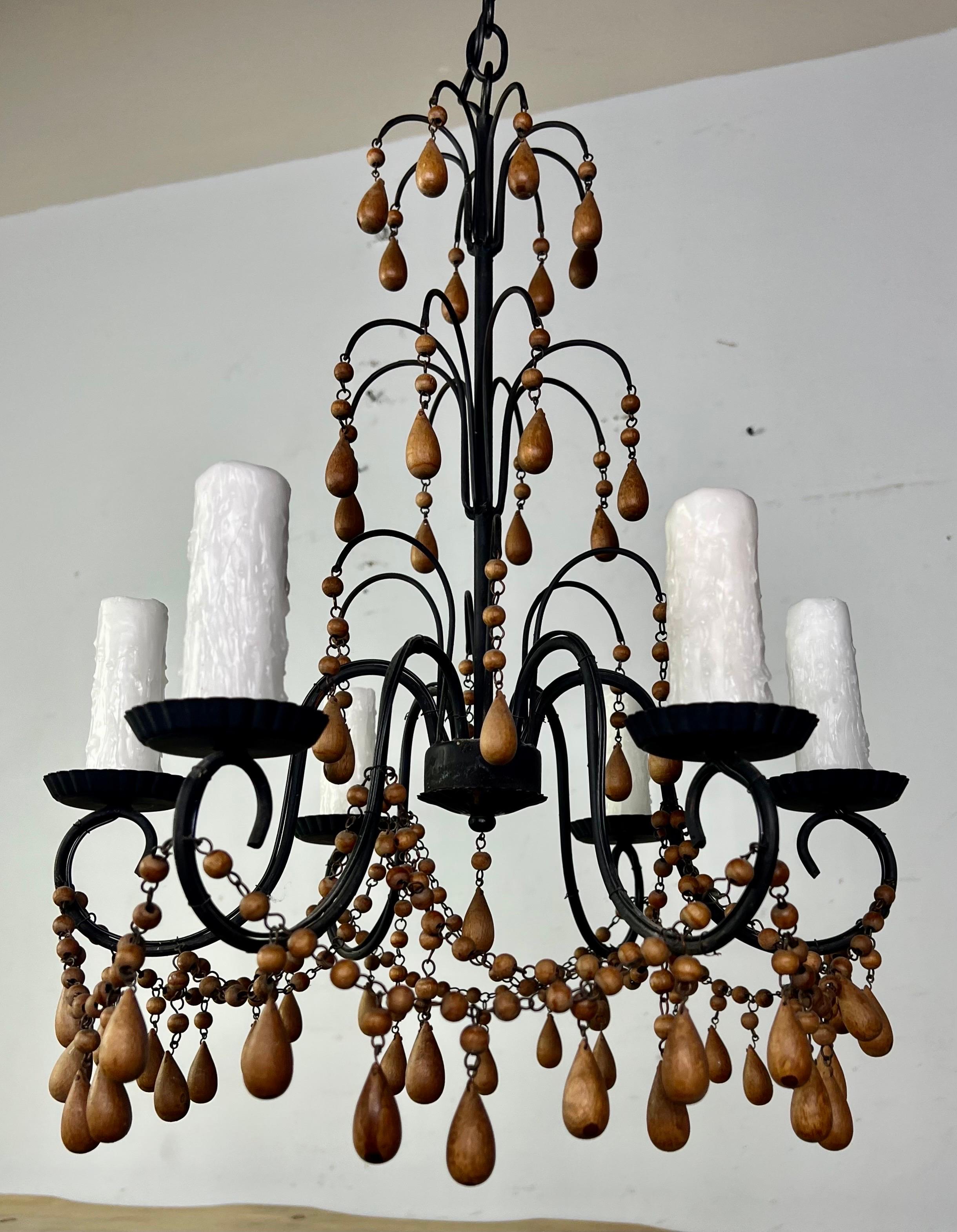 1930s Italian 6-light wood beaded & iron chandelier with natural wood drops throughout. The fixture is newly rewired with drip wax candle covers. It is ready to install and includes chain and canopy.