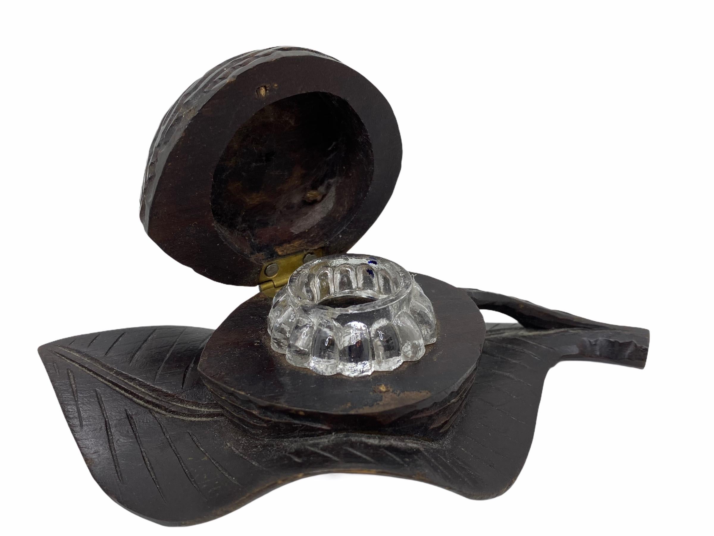 Classic early 1890s Black Forest Brienz wood carved inkwell in form of a walnut on a leaf. Nice addition to your room or just for use it on your desk. Made of hand carved wood and glass. Found at an estate sale in Nuremberg, Germany.